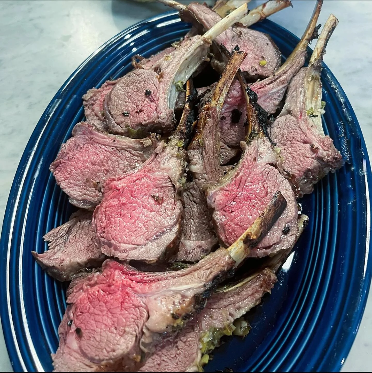 Roasted rack of lamb... perfect Sunday supper.

Ingredients:

2 8-rib racks of lamb
8 cloves of garlic, minced
20 stems of thyme, stalks discarded
1 bunch scallions, sliced
juice and zest of 1 lemon
1 1/2 t sea salt
1/2 c evoo

Directions:

Preheat o
