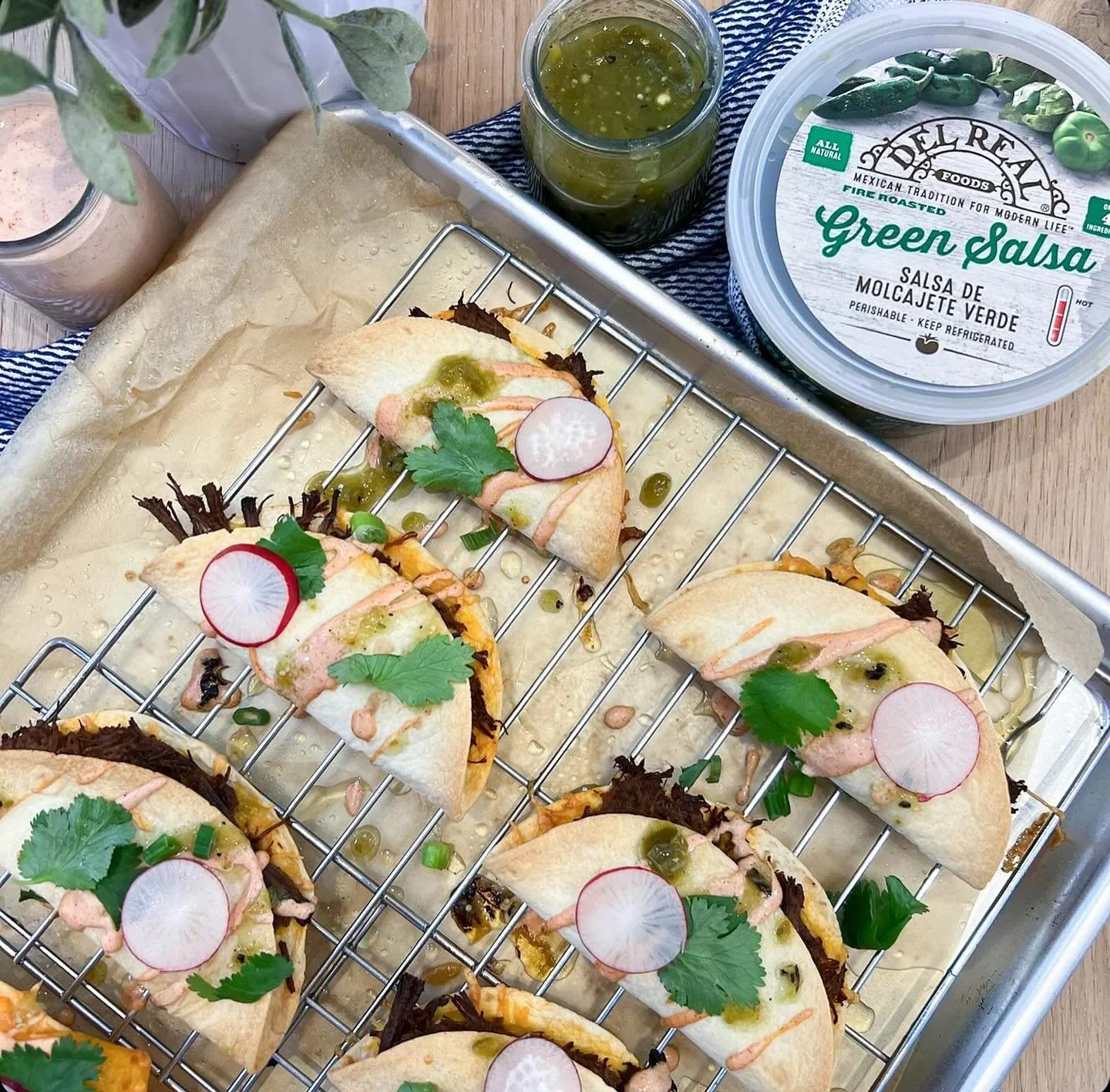 Easy oven baked barbacoa tacos slathered with a smokey, spicy crema are just what you need to get that taco Tuesday party started. 

Ingredients:

1 package cooked @delrealfoods barbacoa
avocado oil spray
8 street taco sized flour tortillas
shredded 