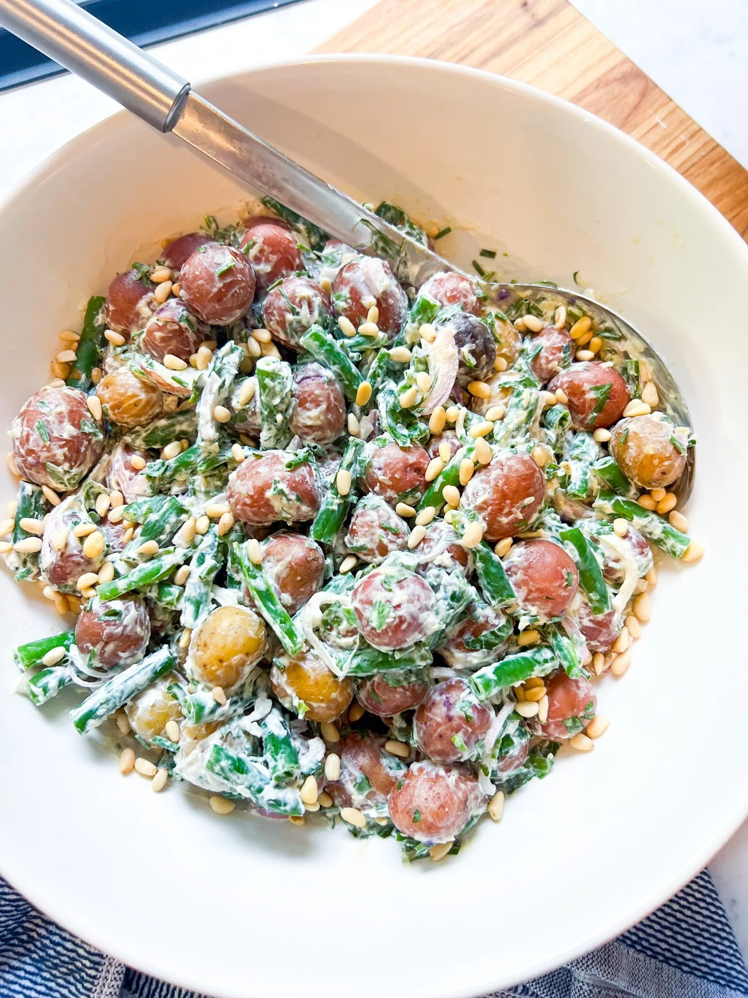 This green bean potato salad is everything...

Ingredients:

1 c sour cream
handful italian parsley leaves
handful of chives, chopped
1 T dijon
1/4 c grated parm
1 t salt
2 packages mixed peewee potatoes, cooked 
2 c cooked french green beans
1 shall
