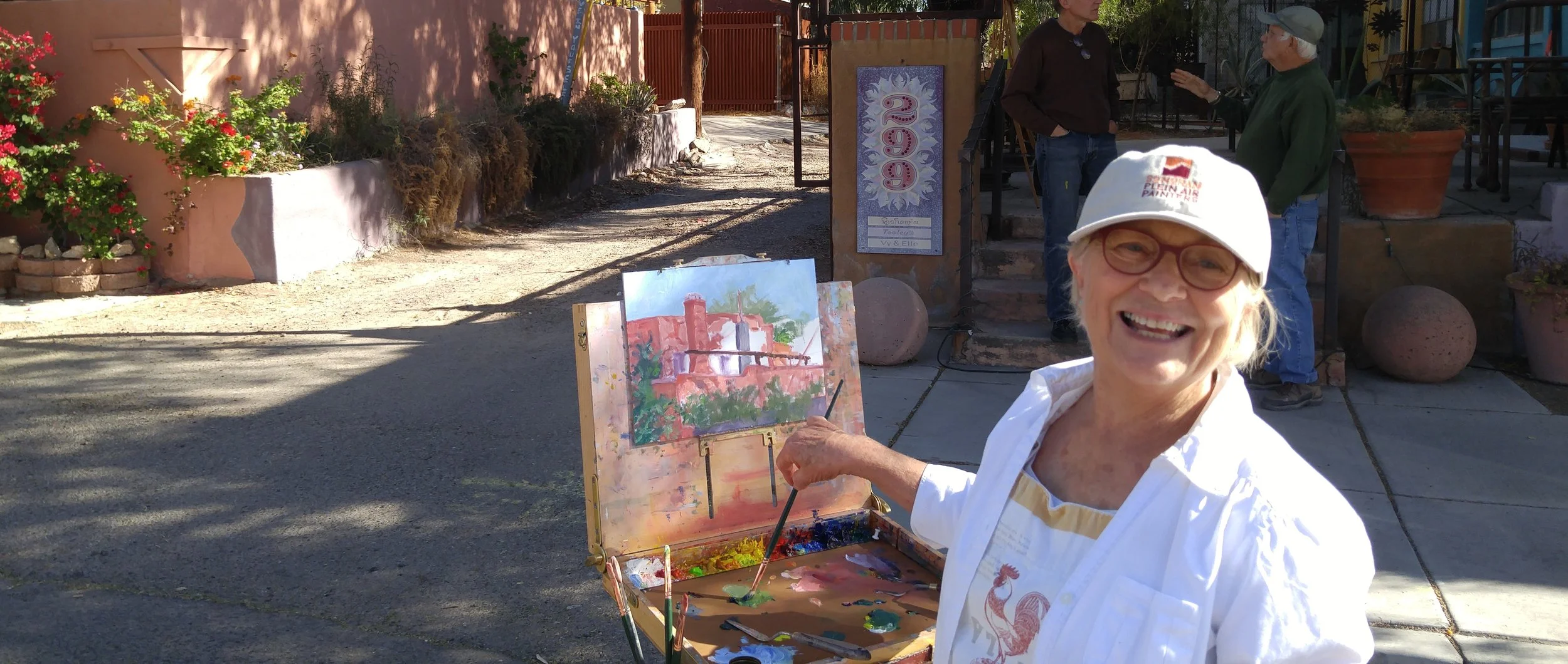 JOYCE NELSON PAINTING WITH THE BARRIO GANG (MEMBERS WHO LOVE TO PAINT OLD BUILDINGS IN TUCSON)