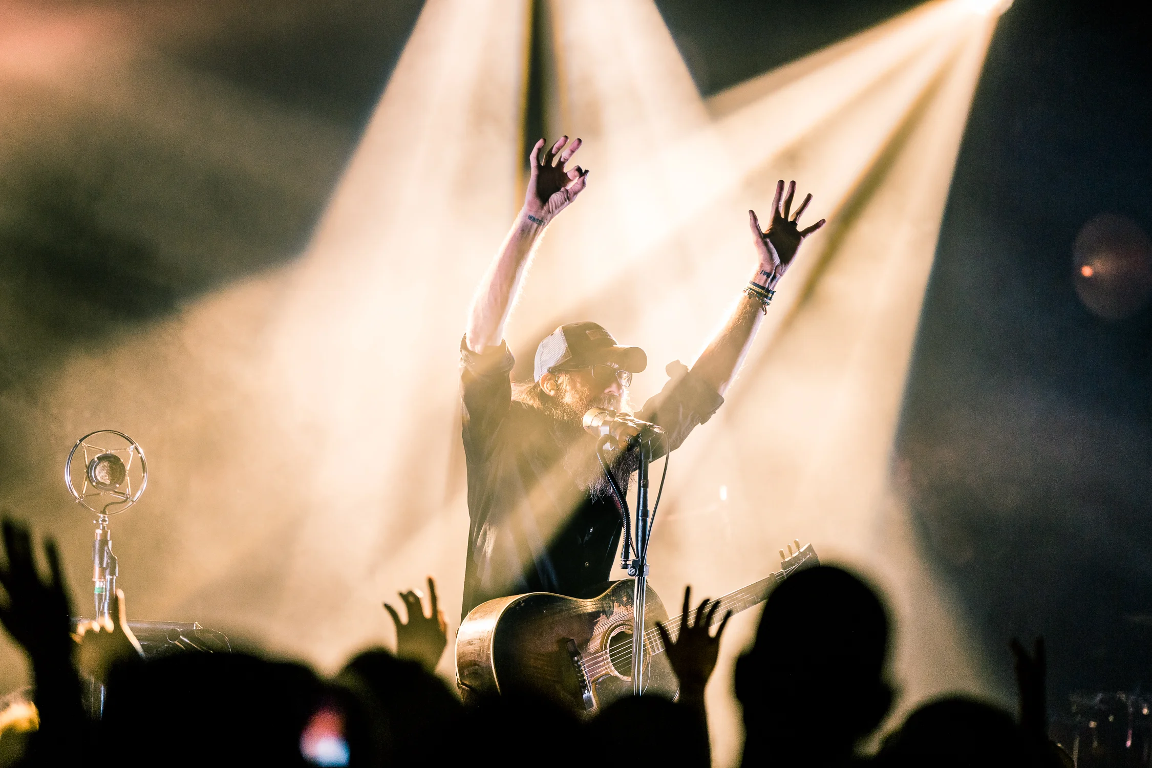 In my opinion this is the stronger image because of the parallel between David Crowder's raised hands and the single audience member's who is perfectly in line with my camera. This creates more emotion in the image and conveys more of a story/meaning.