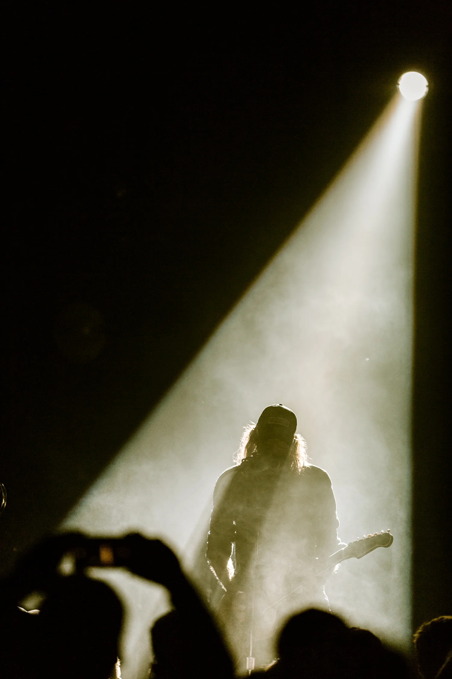 As a live music photographer you have to be ready for sudden changes. This shot came out of nowhere when the lighting changed suddenly. I dropped my exposure by a stop and a half by shortening my shutter speed because I didn't want any background details surrounding Crowder and create this silhouette feel.