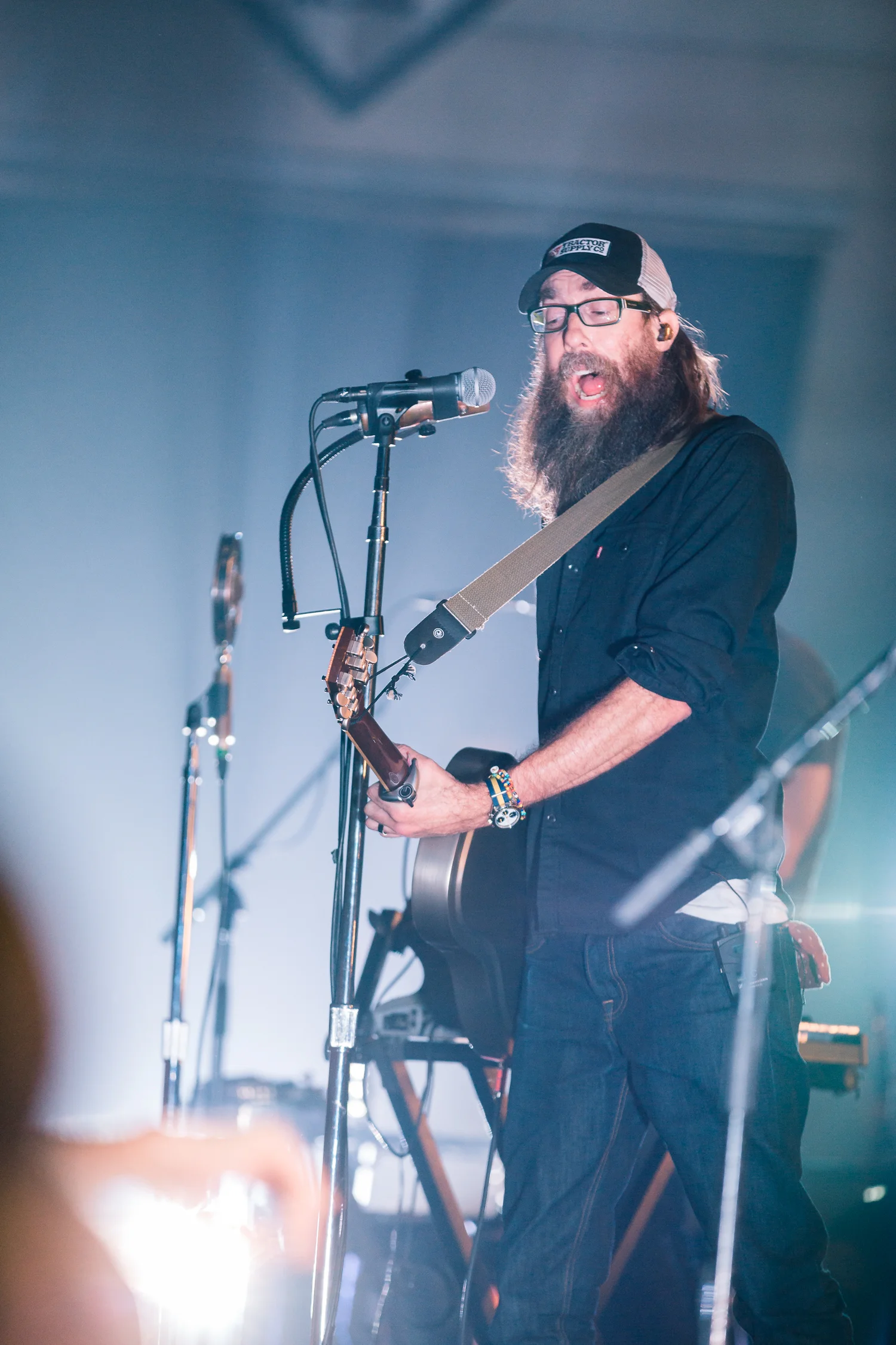Not everything has to be super dark or moody to make for a good concert photo. When you get in the right position and have your exposure set for a light to flash over a singer's face you can get some fun expressions out of your subject.