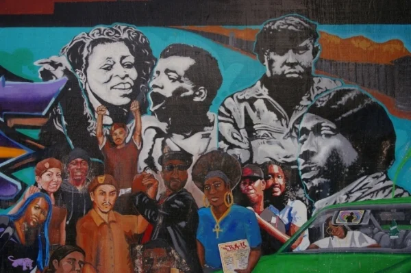   Section 7: This mural detail connects different neighborhoods, folks and communities that have been victimized by the Eurocentric system. Connecting low riders and scrappers connects African American culture and Latino culture. The Black Panther pa
