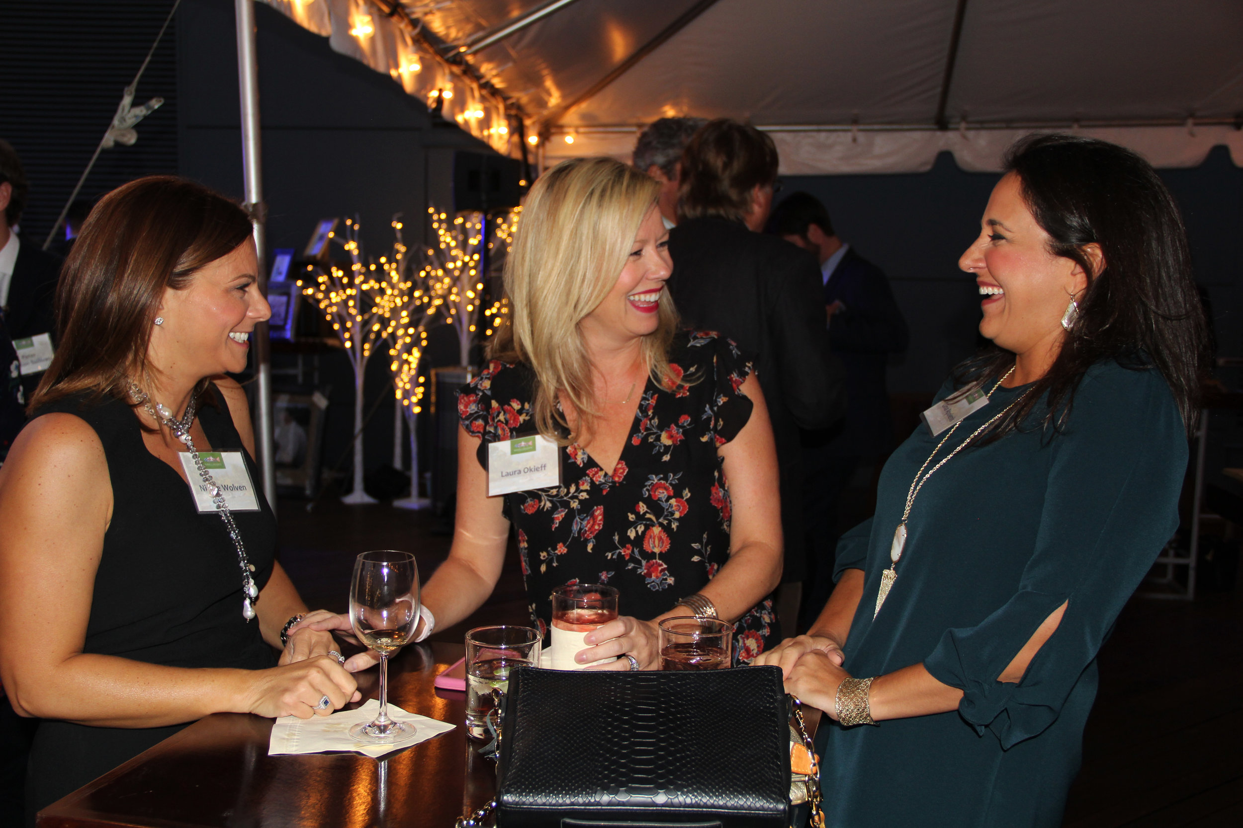 Three women socializing at event