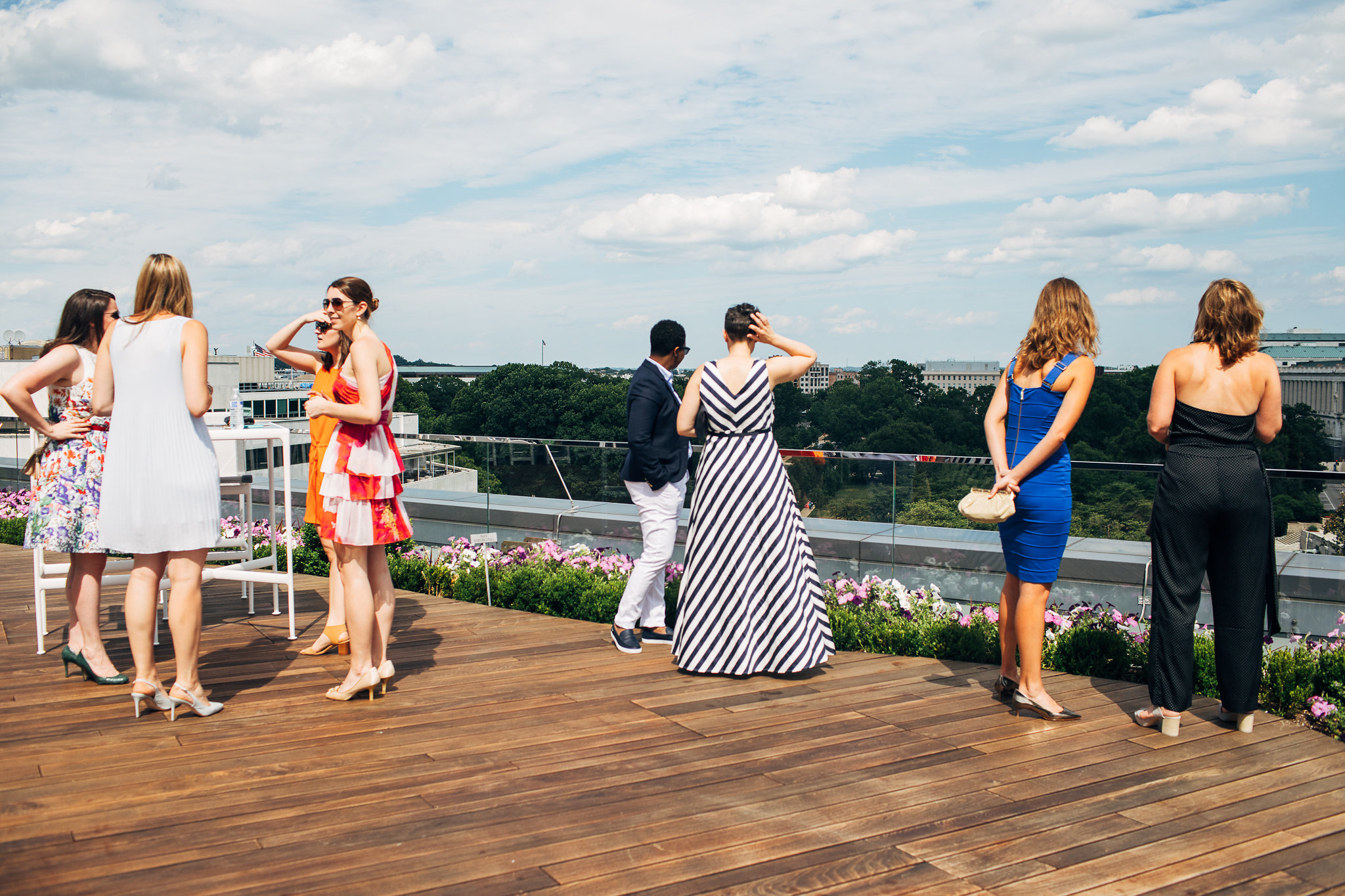 Event attendees socializing on the rooftop deck