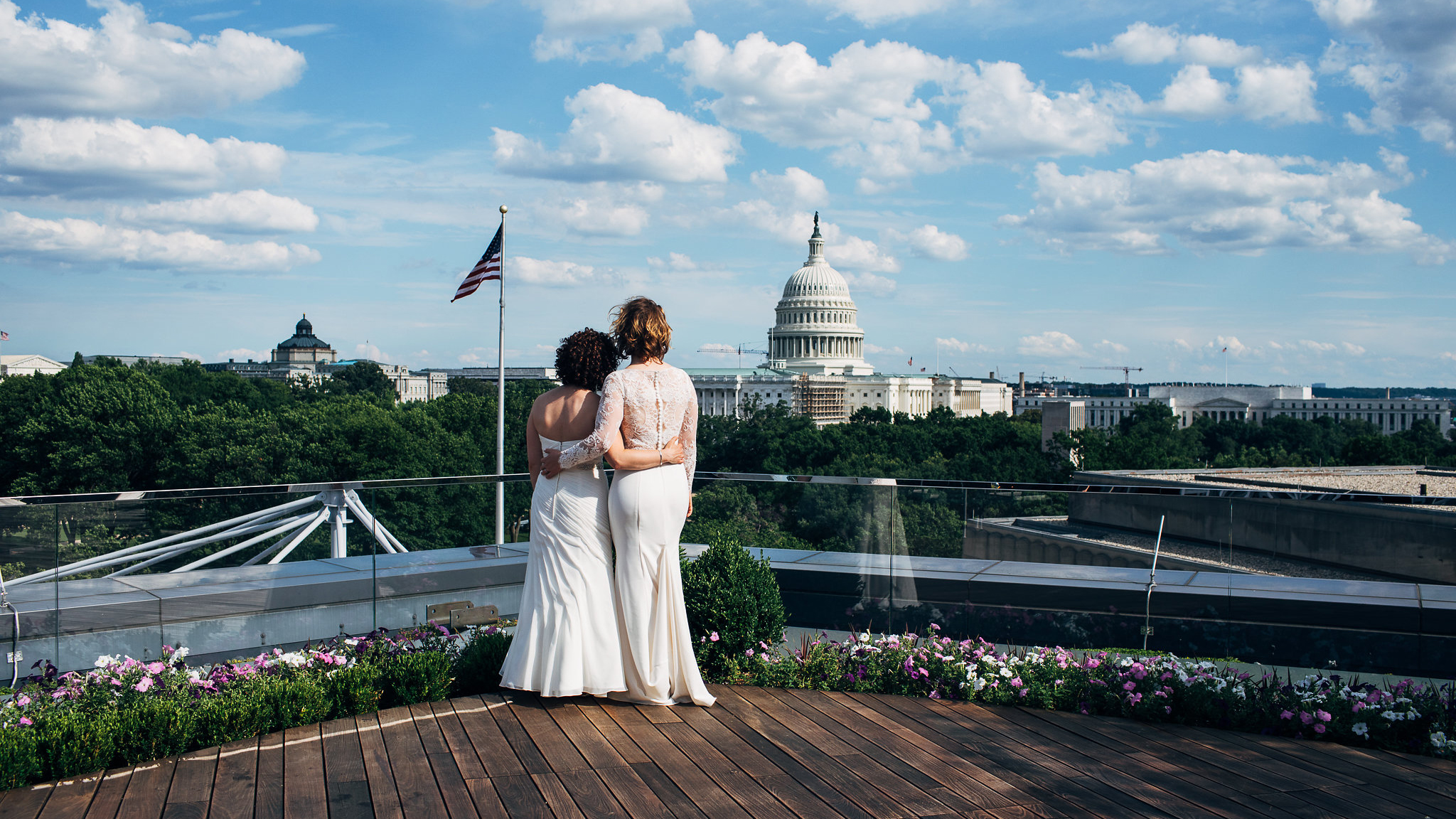 Engaged couple taking in view of Capitol building at their wedding at the rooftop event space