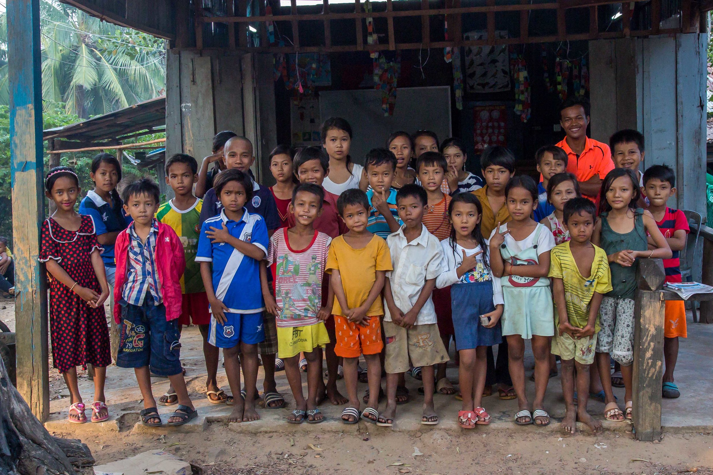 Group shot of the students and Mong in front of the Family English School. Photo: Gina Orlando