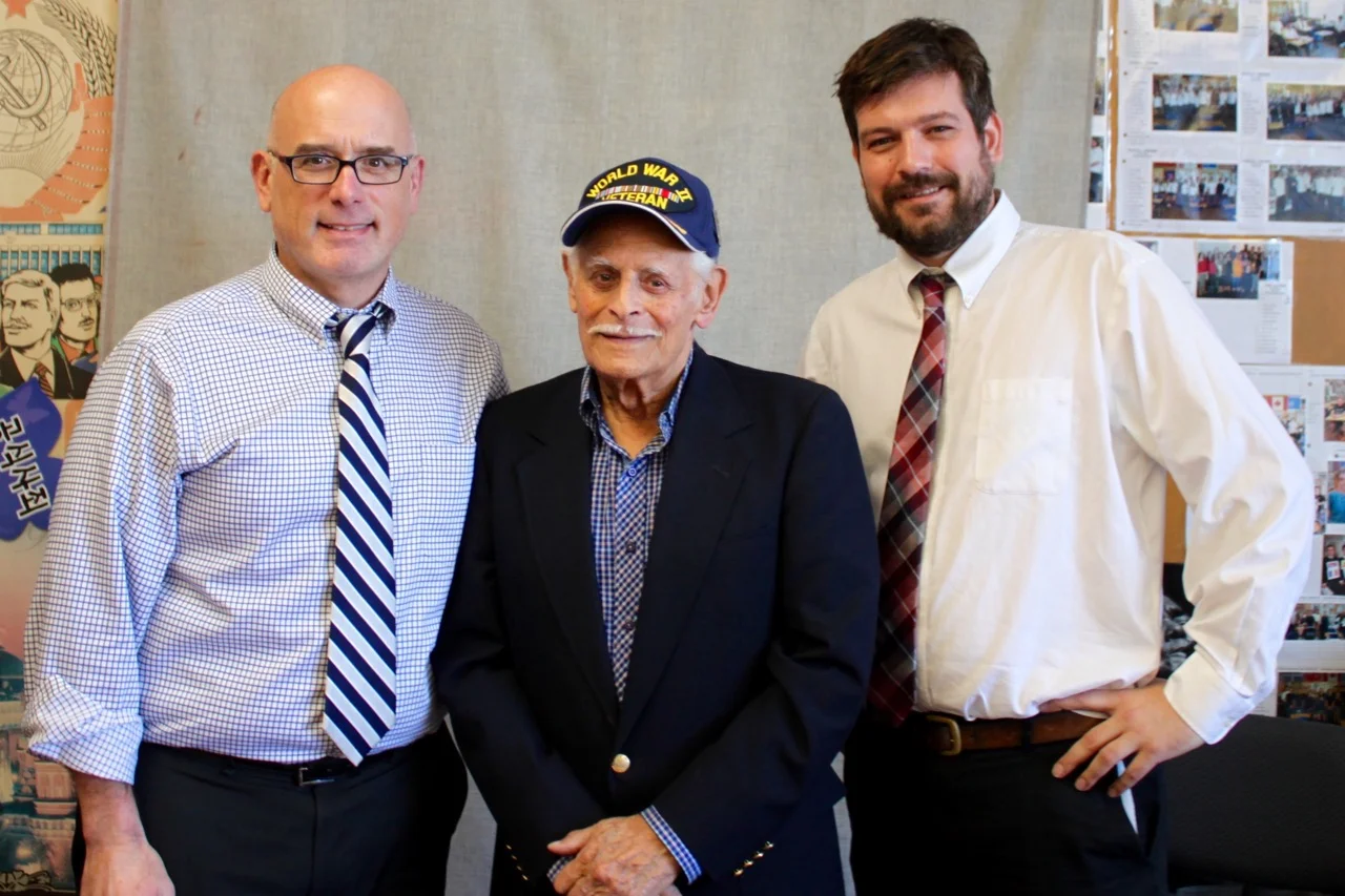 Teachers Scott Masters and Jason Hawkins with Second World War veteran Jack Boeki.
