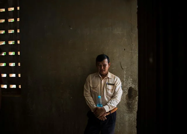 MR. OM CHAMBROEUN ON HIS JOB: "SOME DAYS IT'S OKAY; OTHERS, IT'S NOT." PHOTO: ANITA BONNARENS