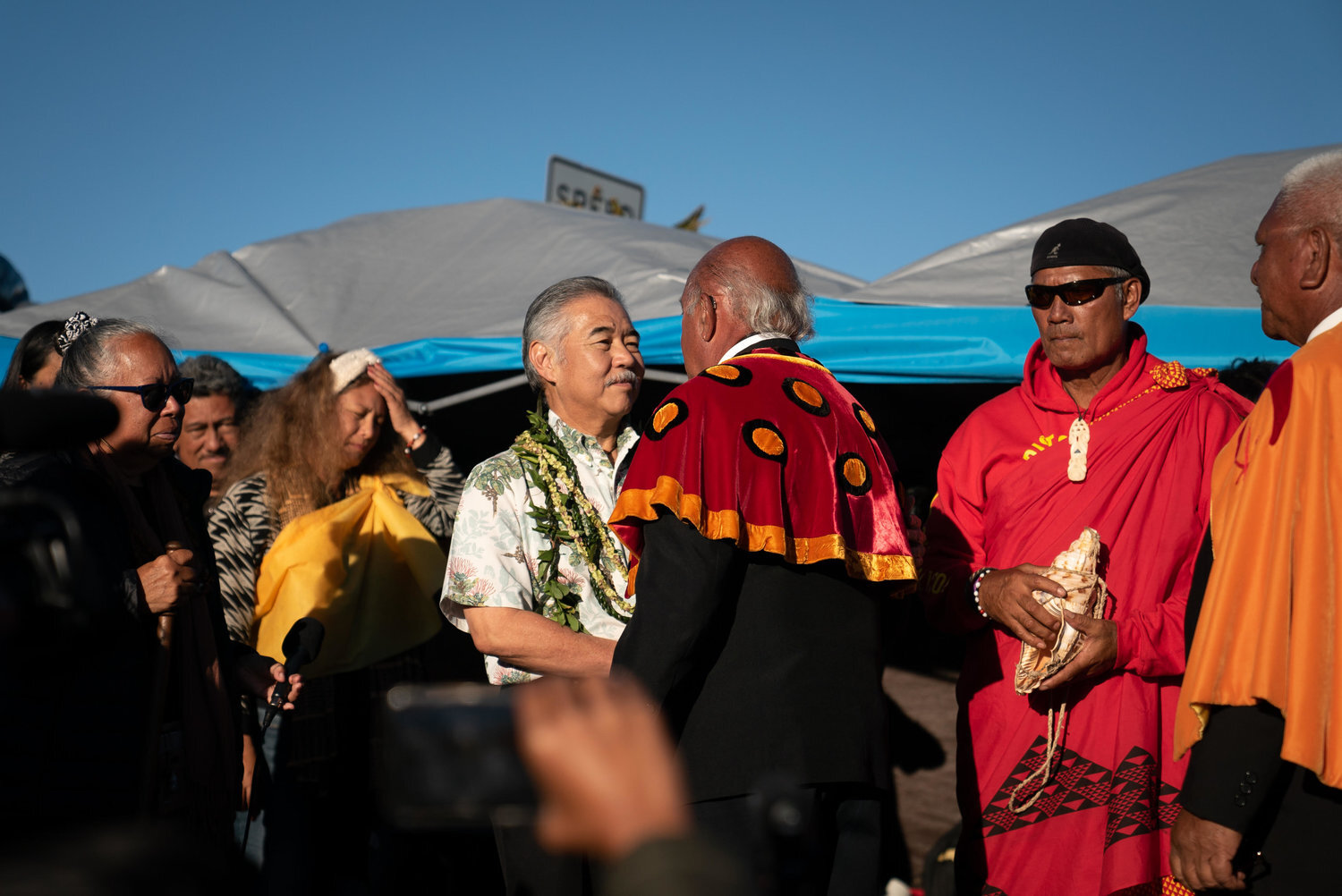 Governor David Ige arrives on the mountain after declaring a state of emergency and is greeted by the Royal Order of Kamehameha.