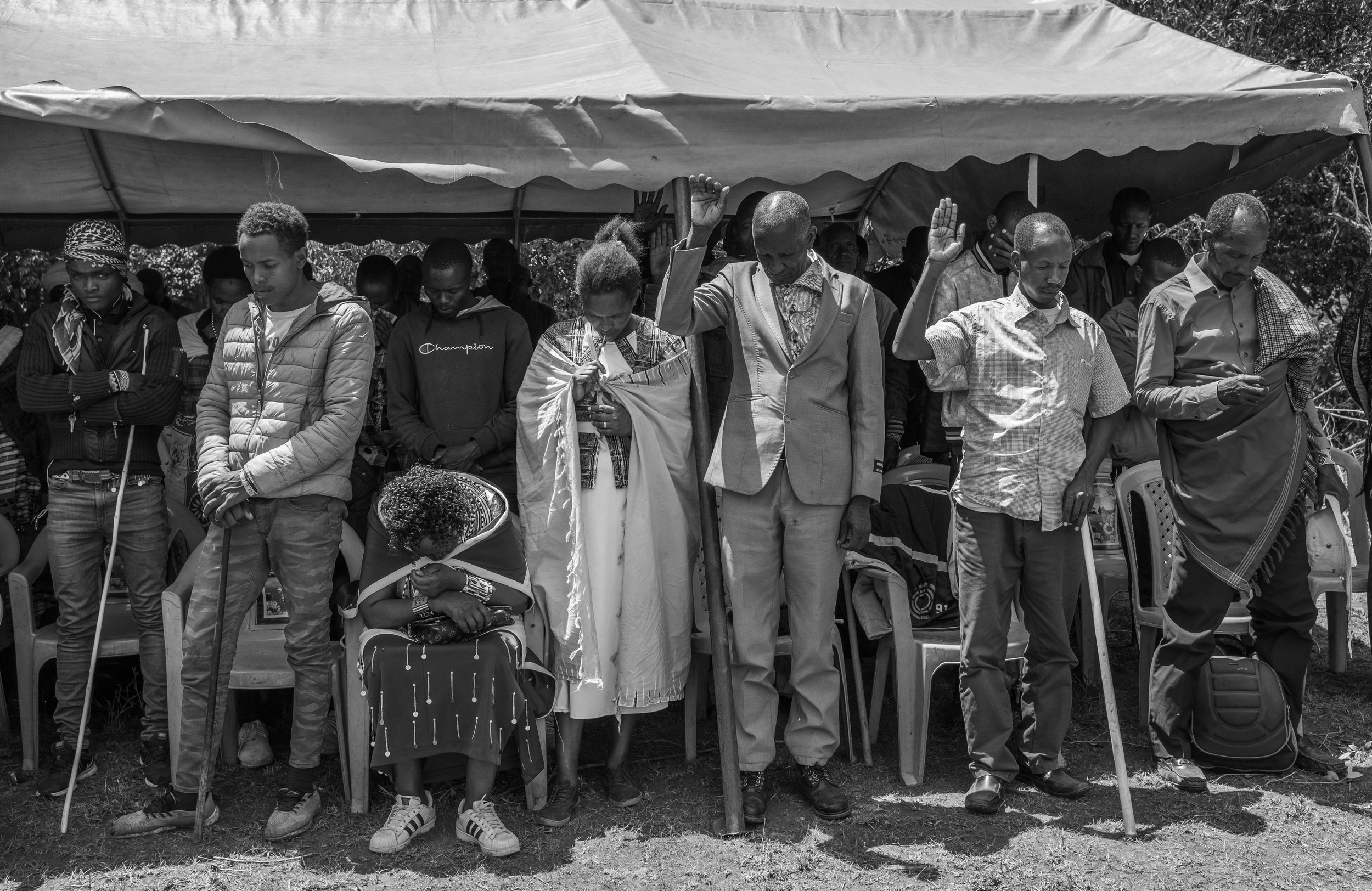  Community land members open the Annual General Meeting to discuss the joint land issues with a prayer, Lukusero A village, Laikipia county, Kenya. 