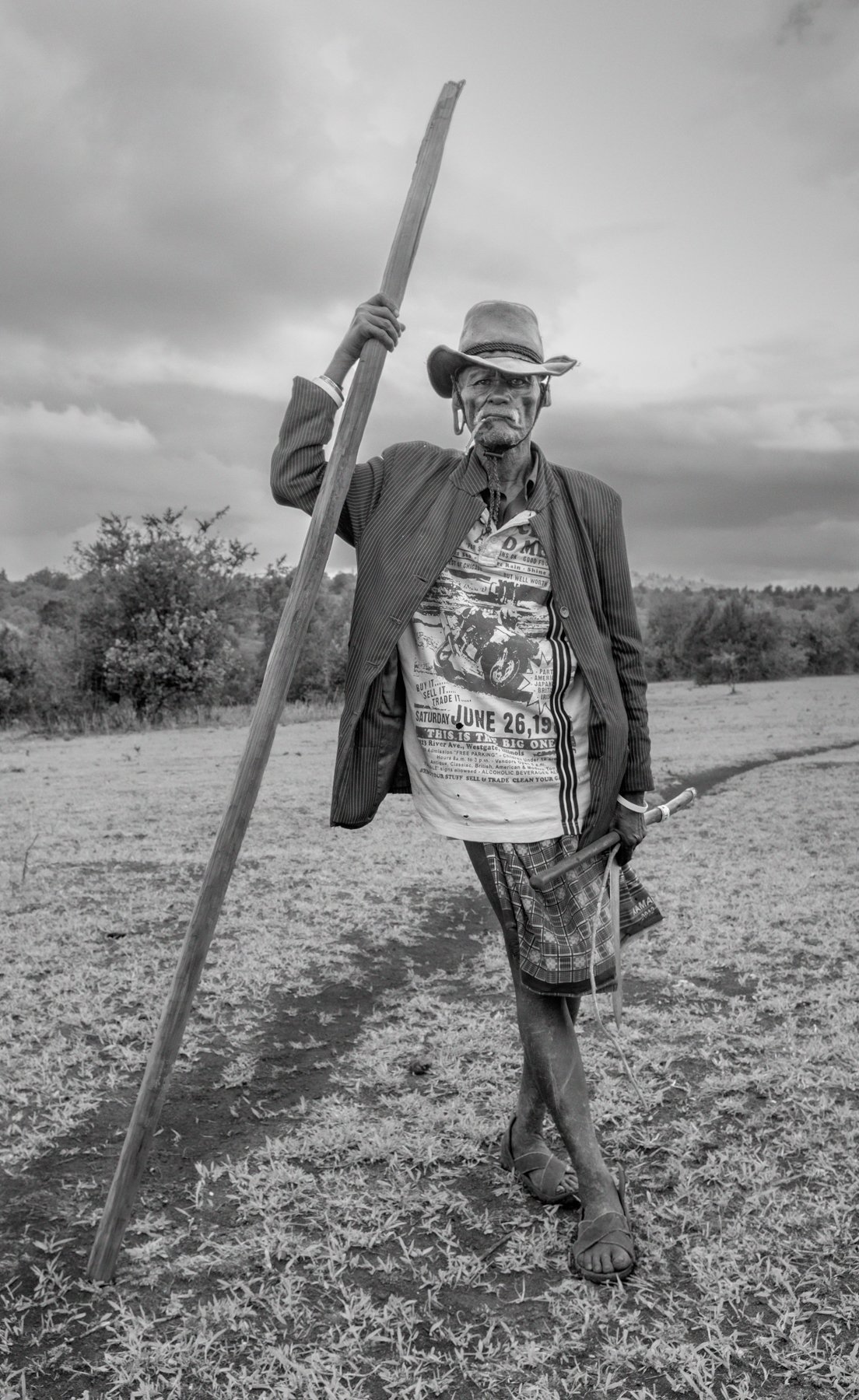  Sioya Kisio, 89 years, poses after returning from herding his cattle and goats. He is John›s older brother and the first born son of Mau Mau general, Kurito Ole Kisio. Nadumoro village, Laikipia county, Kenya.  