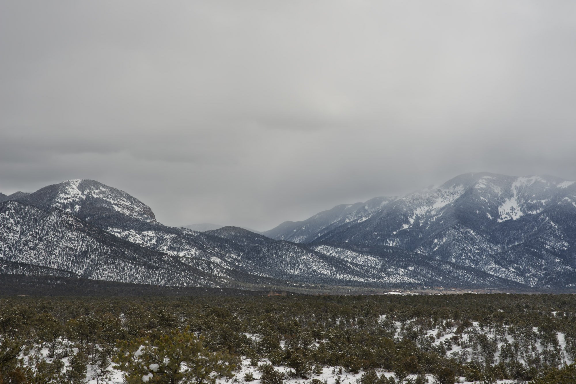   Late winter landscape in the Sangre de Cristo mountains, Lucero Peak and El Salto to the left, Taos Mountain and Taos Pueblo to the right.  