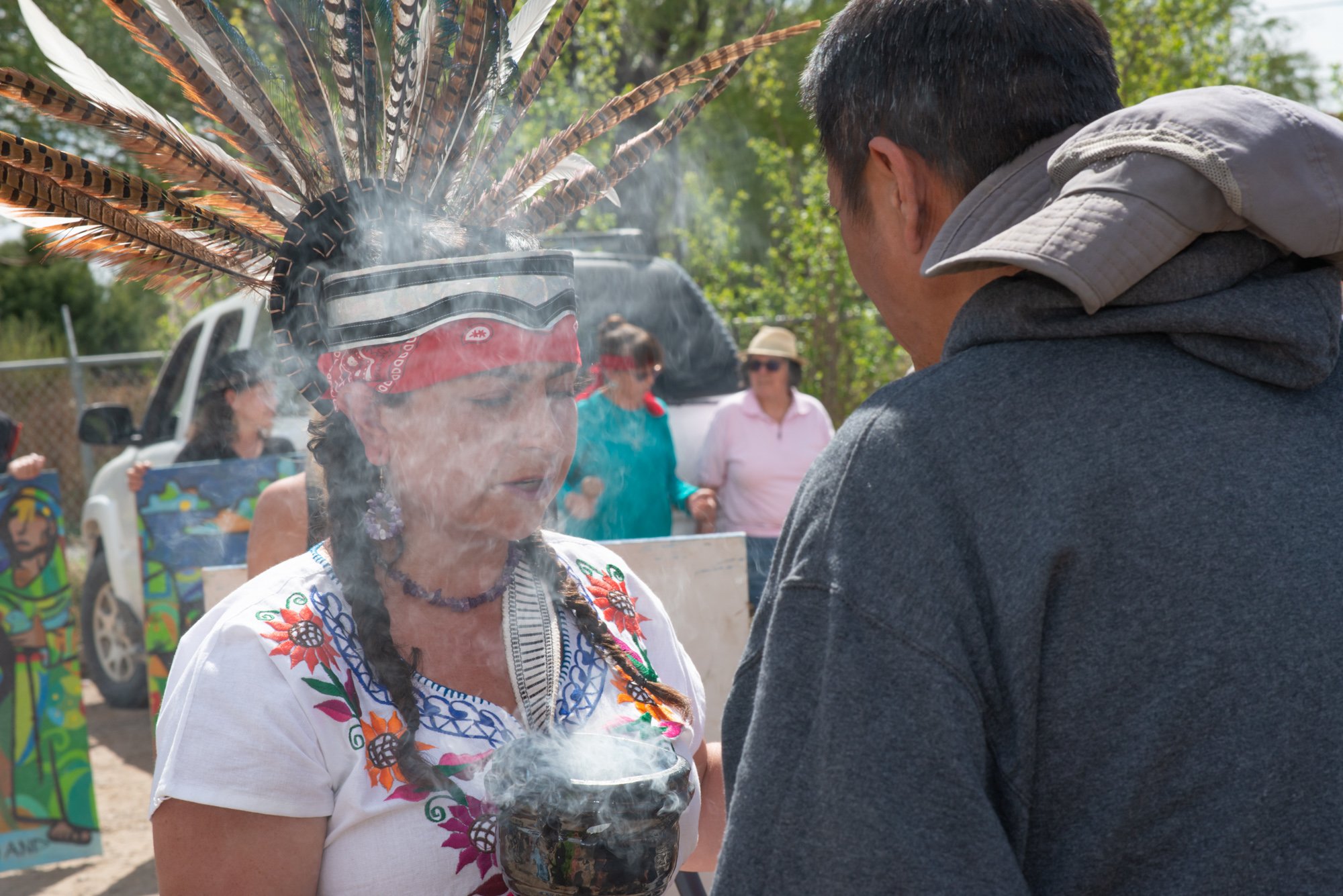   Local pueblo tribal members perform a cleansing smudge ceremony during the rituals of San Ysidro Festival.  