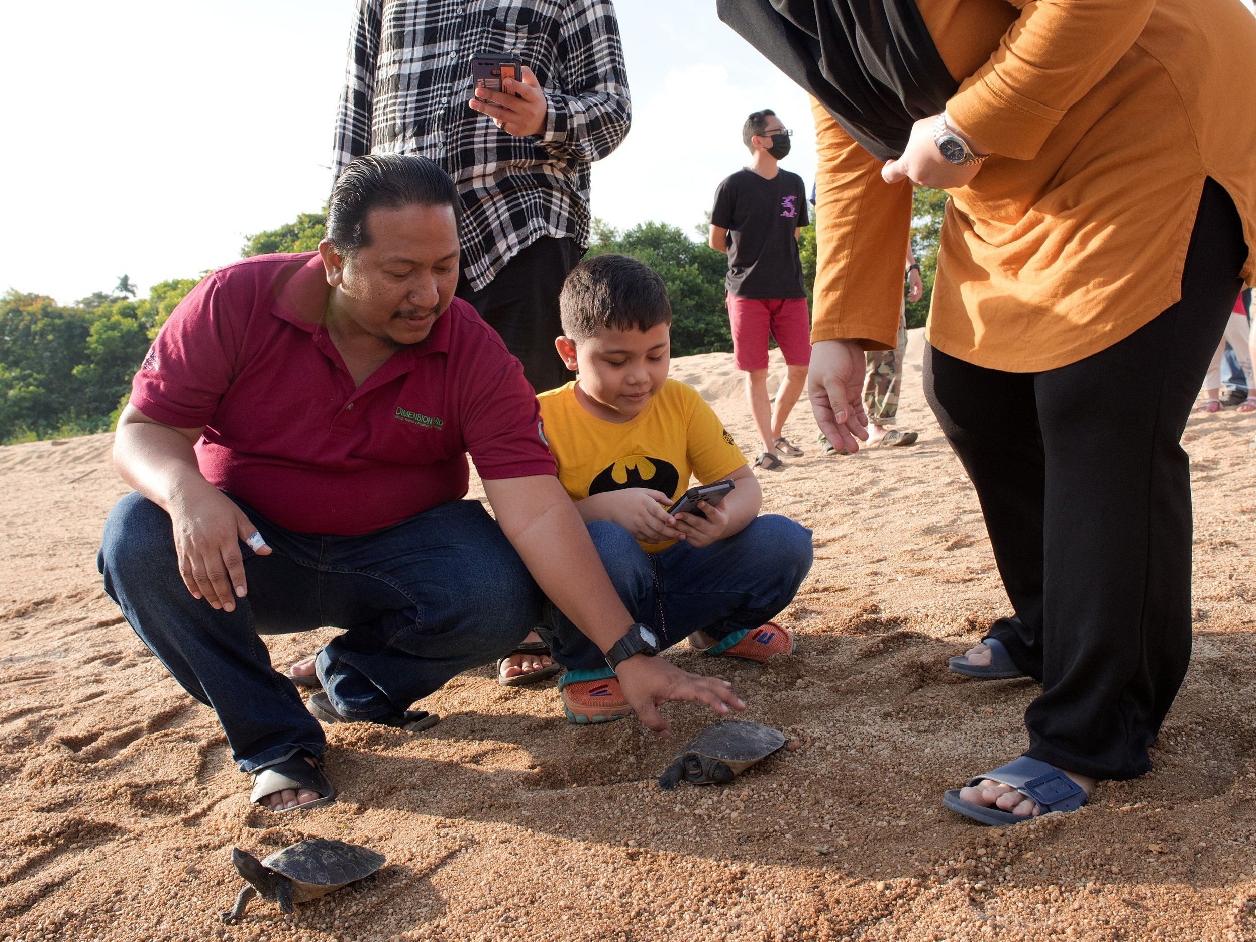 Local villagers are coming together to release young terrapins into the river.