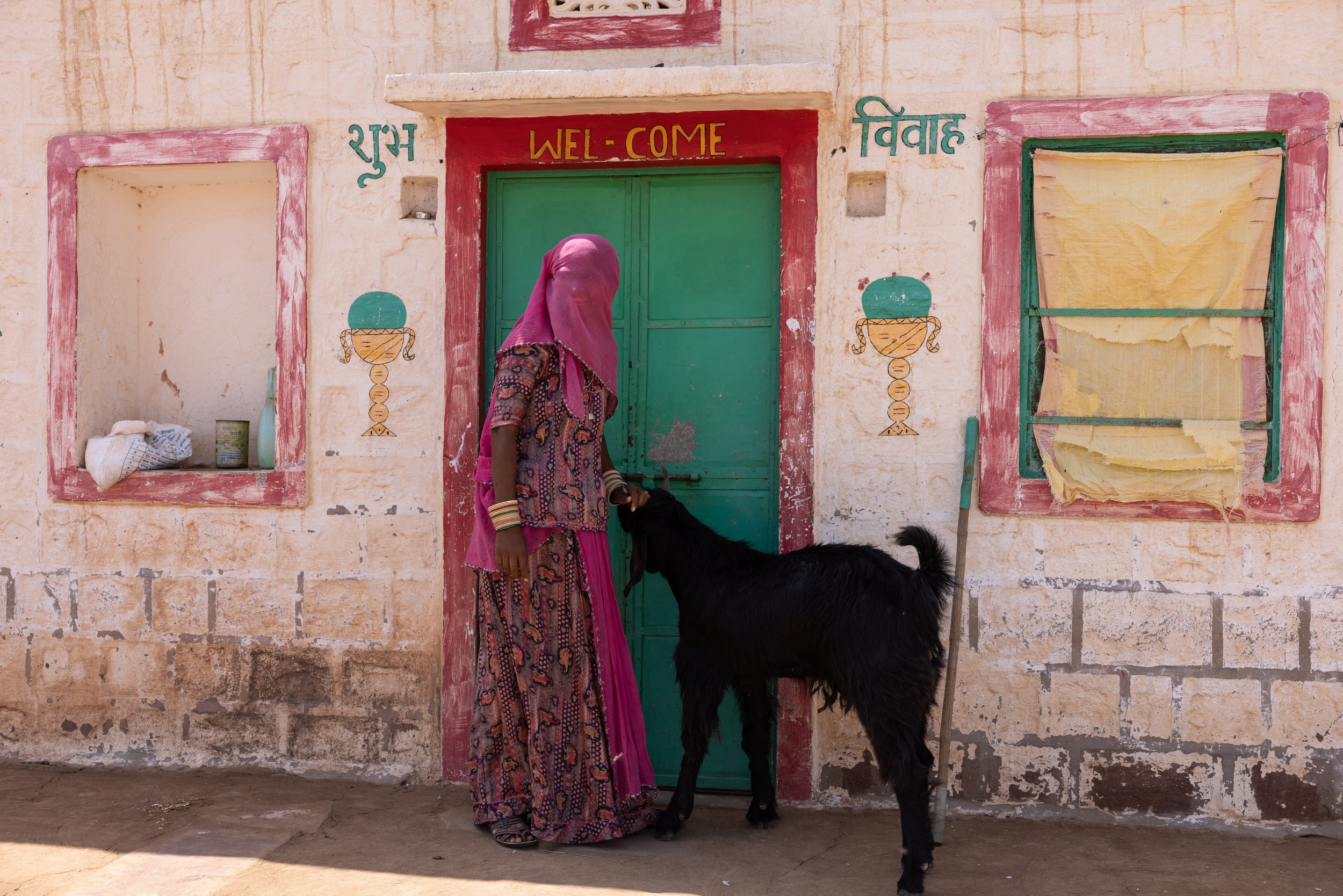 Sunder Devi outside her house with one of the family's precious goats.