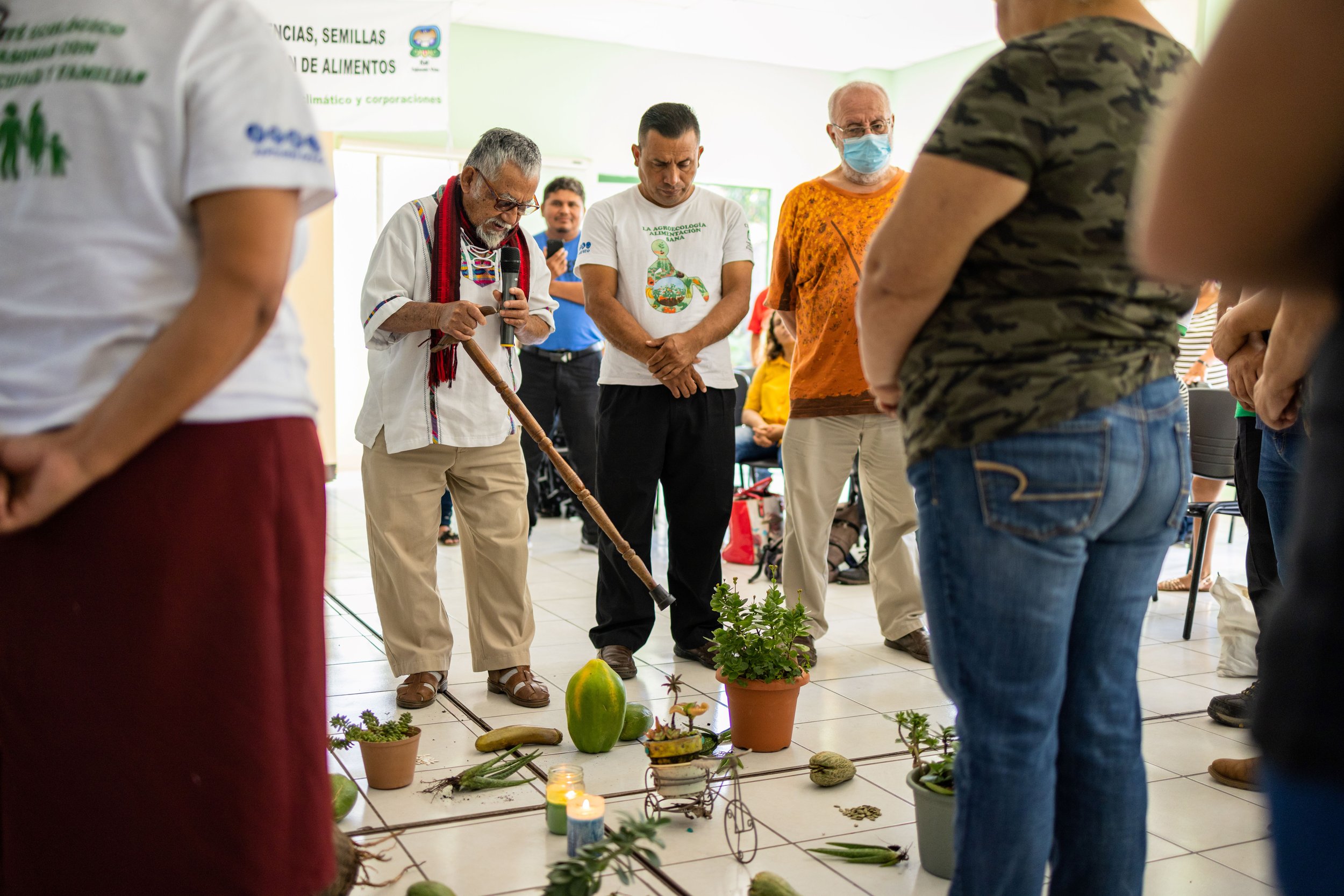An Indigenous leader leading a blessing ceremony for the seed exchange event.