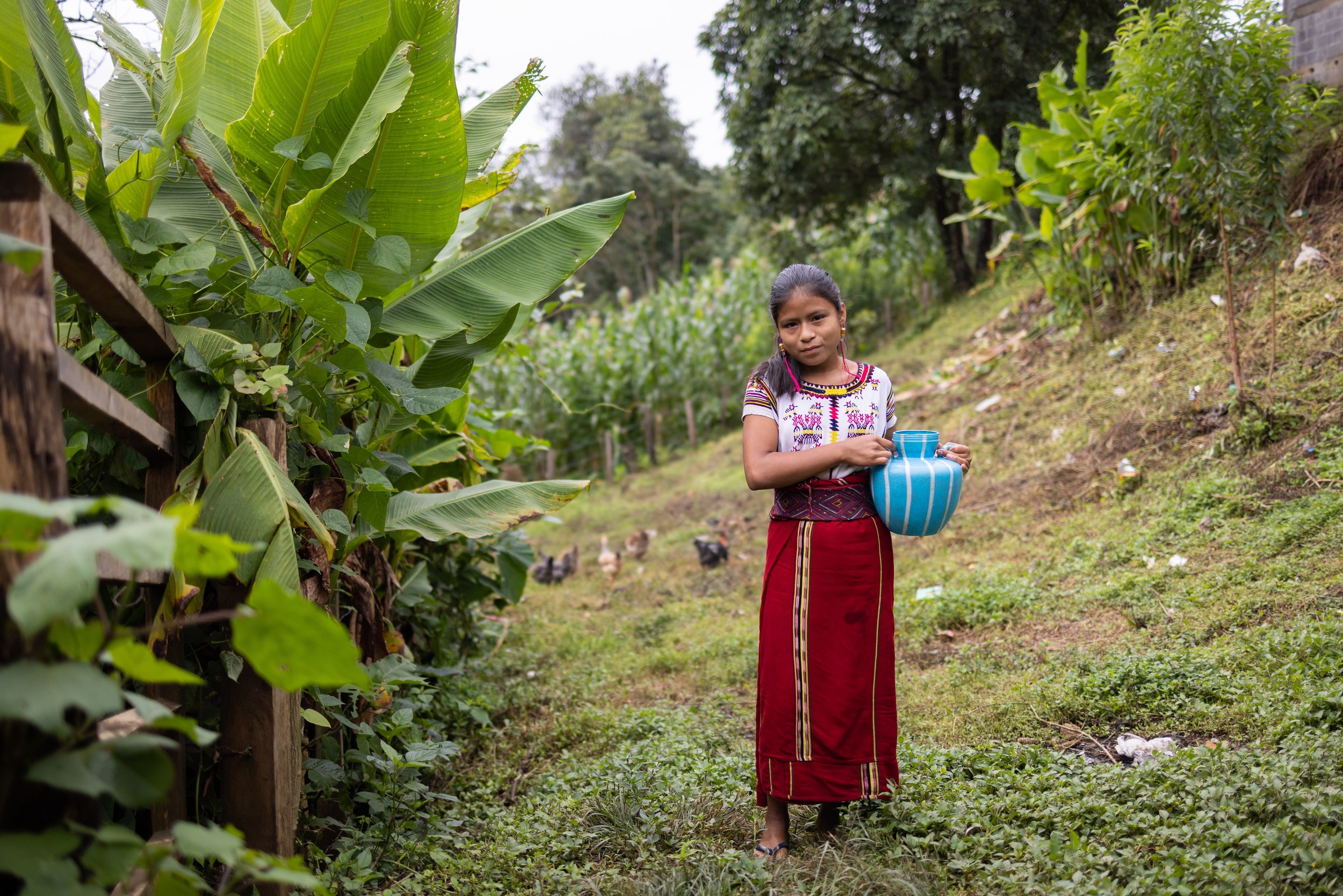 Cristina Matom, a student in Colegio Horizontes’ inaugural class, carries water back home. Her family now has convenient water access, but before it was a long journey for her to collect water.