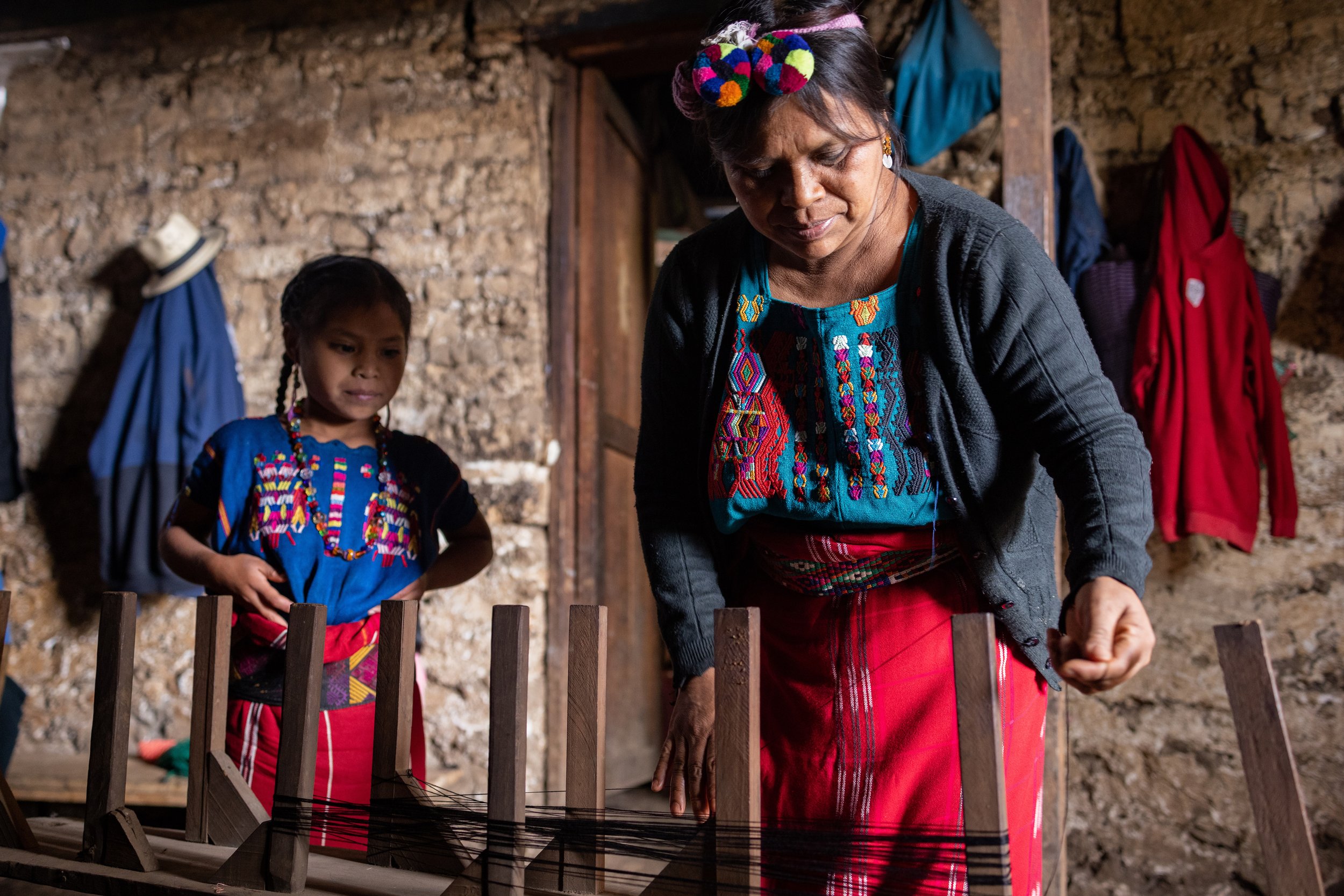 Ana and her daughter start the process of huipil-making in their home, getting the yarn in the right order to then be placed on the backstrap loom.