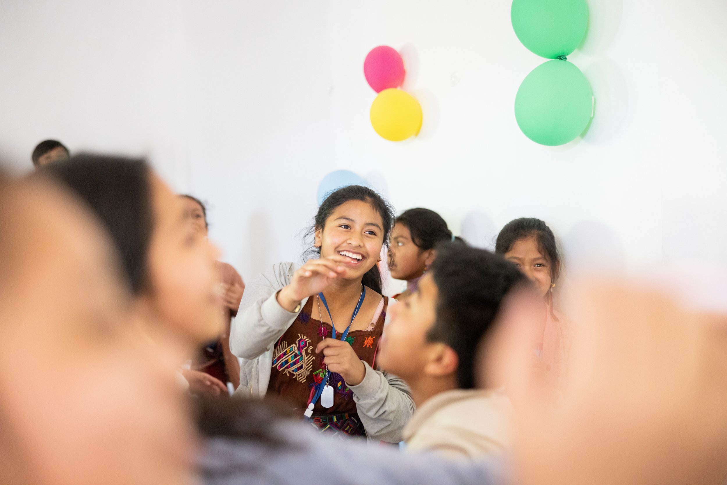 Students take a break from classwork to play games in the cafeteria at their school, Colegio Horizontes.