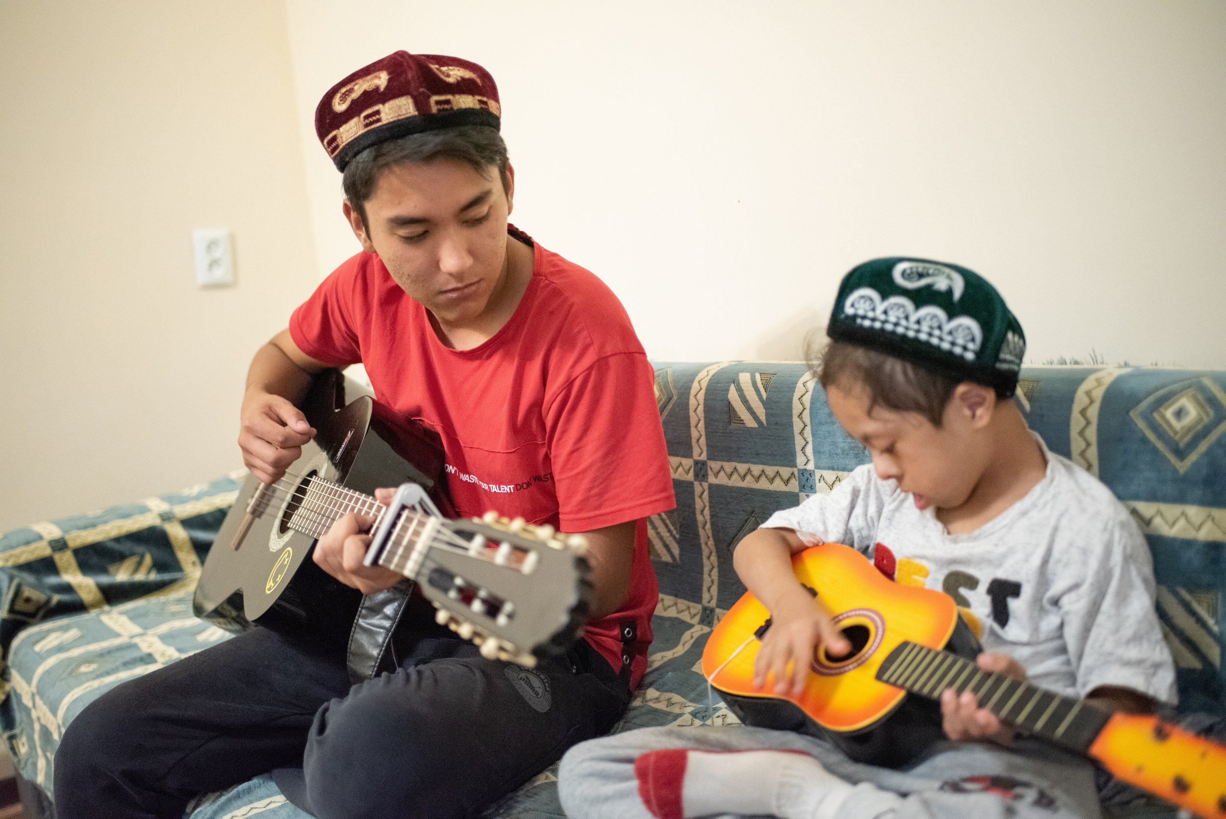 Akram plays with his little brother Aliakbar. 