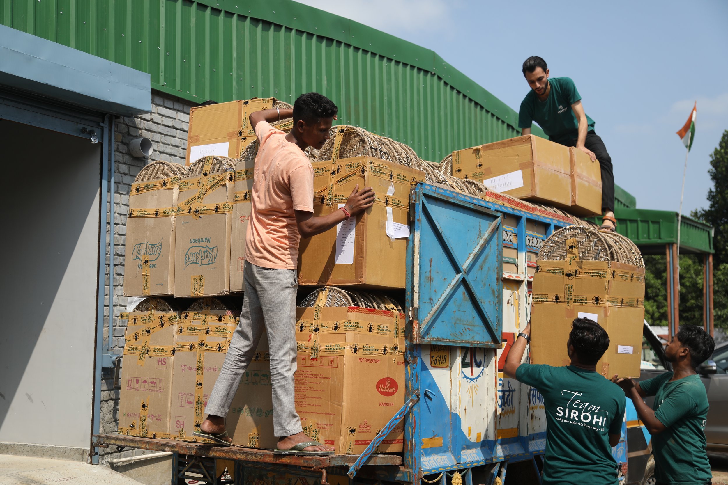 Employees of Sirohi in Muzaffarnager can be seen here loading finished products onto a delivery truck. The Sirohi factory stores finished goods, which are quality-inspected and packaged for delivery.