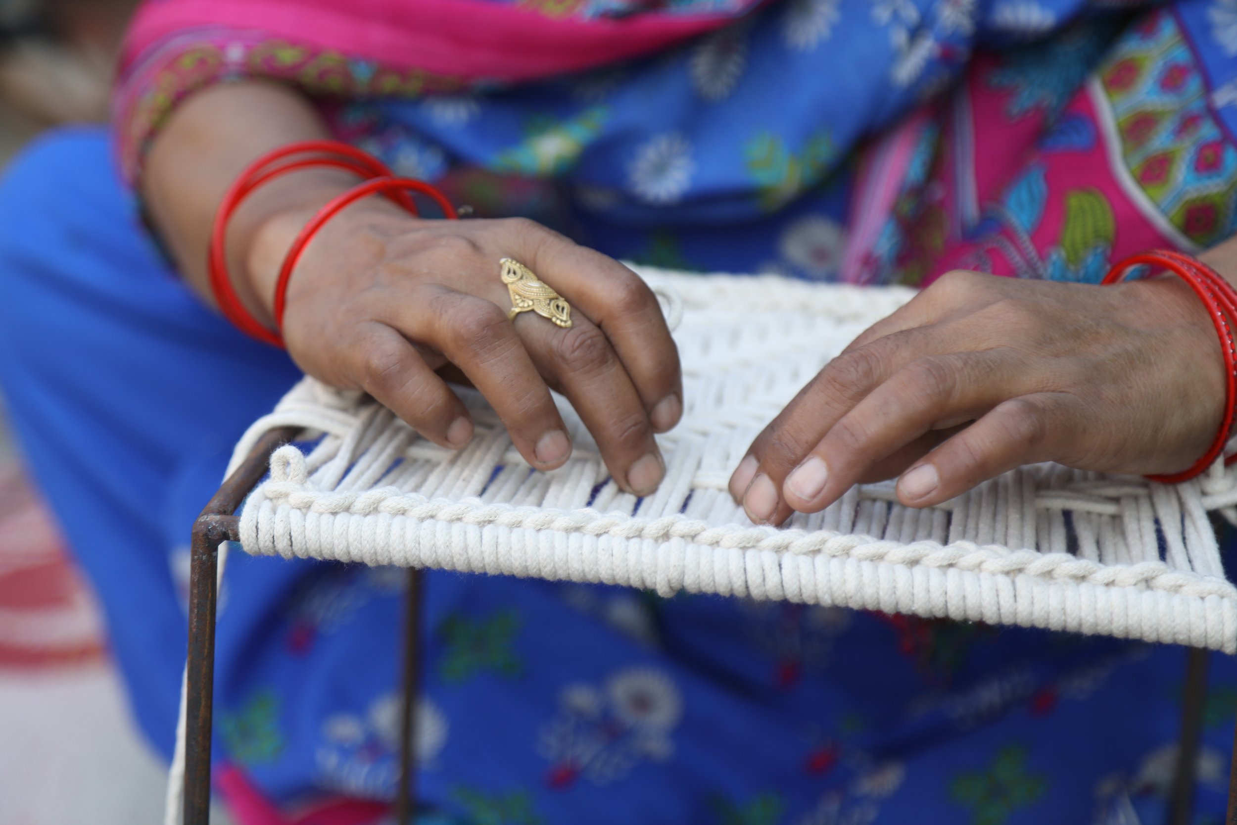 Women weavers help produce dozens of products a day for Sirohi that include trays, benches, chairs, stools, and boxes. They earn approximately 10-15,000 rupees a month.