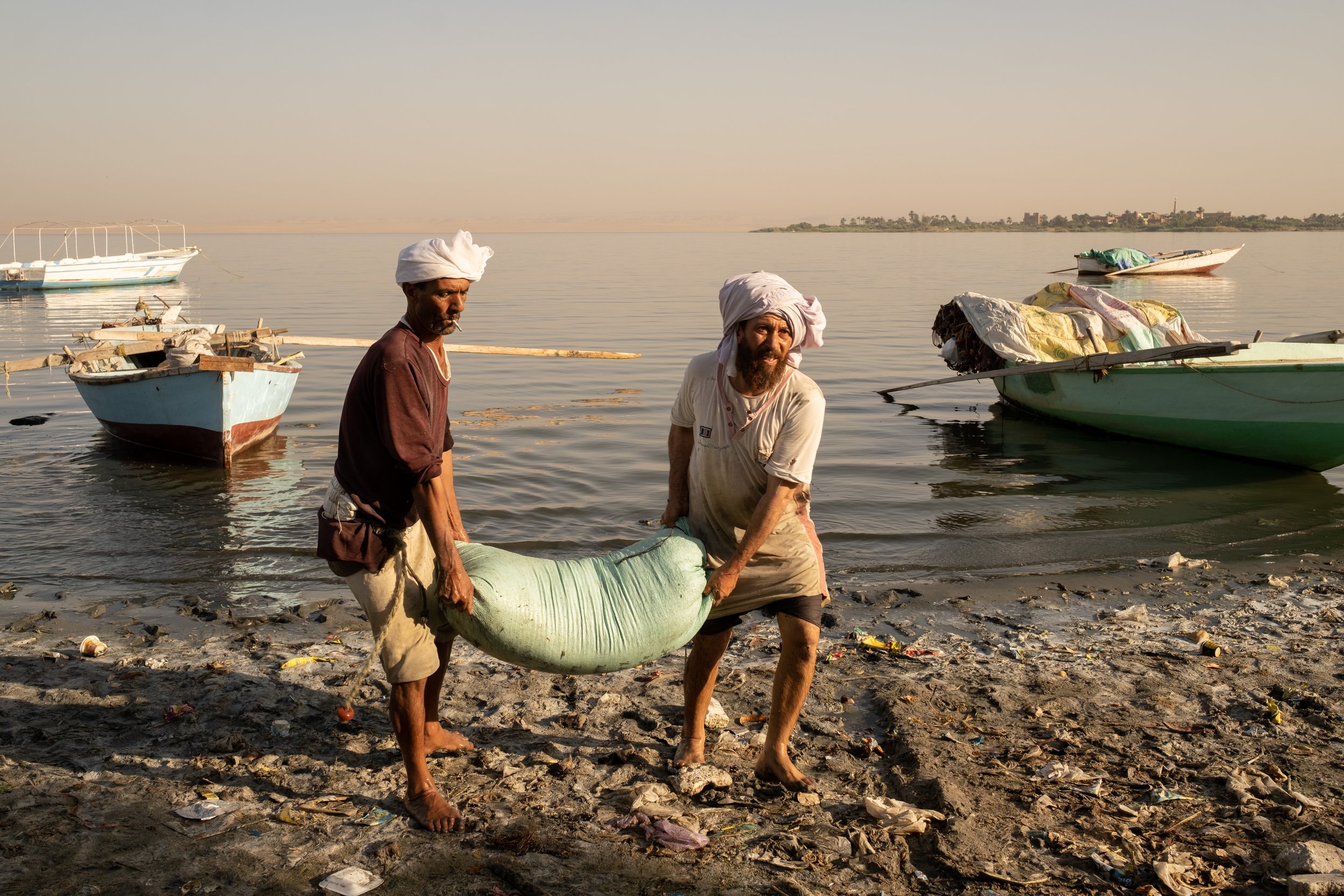 Fishermen unload their catch from Lake Qarun in the early morning. Their livelihood is threatened by overfishing, unsustainable fishing techniques, pollution, climate change, and habitat degradation.