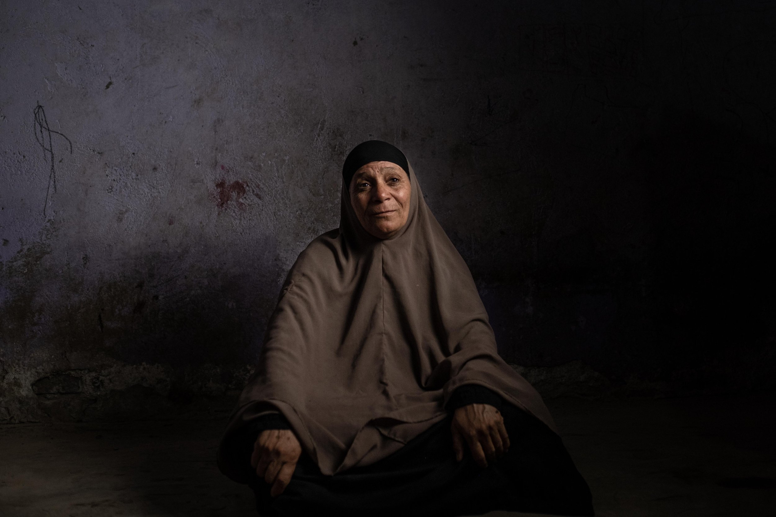 A woman, Ajab Muhammad Miftah, 54, poses for a portrait. She lost her husband and two of her sons in a microbus accident during a trip to Aswan in search of a better living. September 22, 2022.