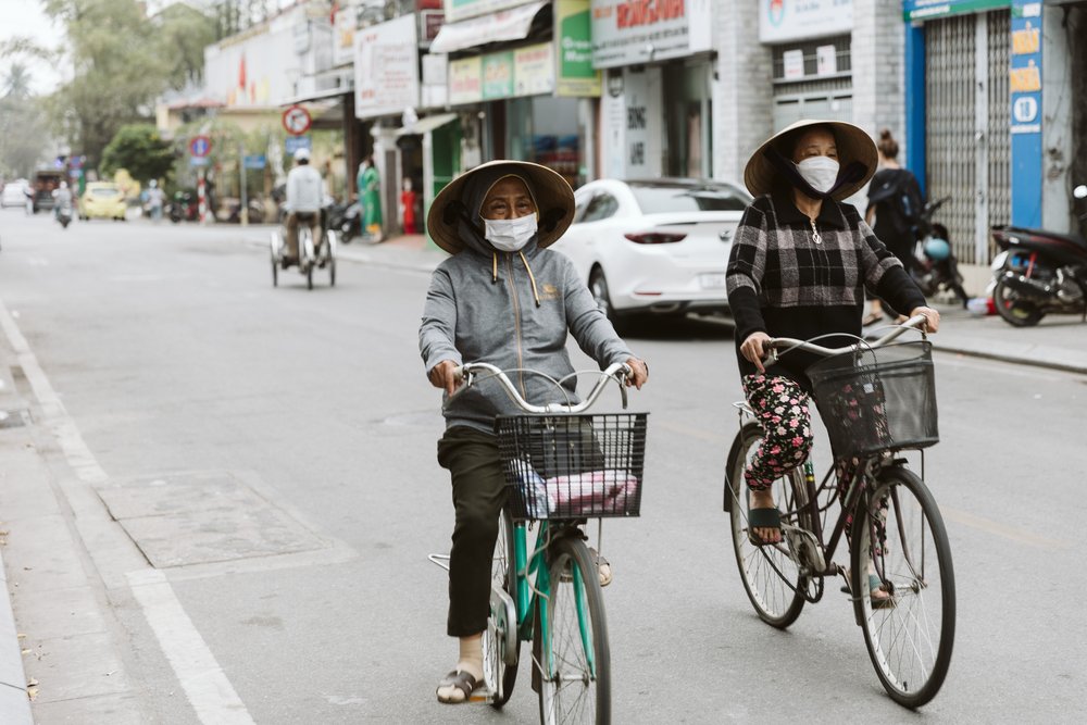 People travel mostly by bicycle, motorbike, or cyclo throughout the city of Hue.