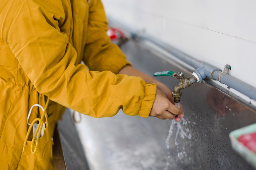 A girl at the Quang Phu school washes her hands at the handwashing station.