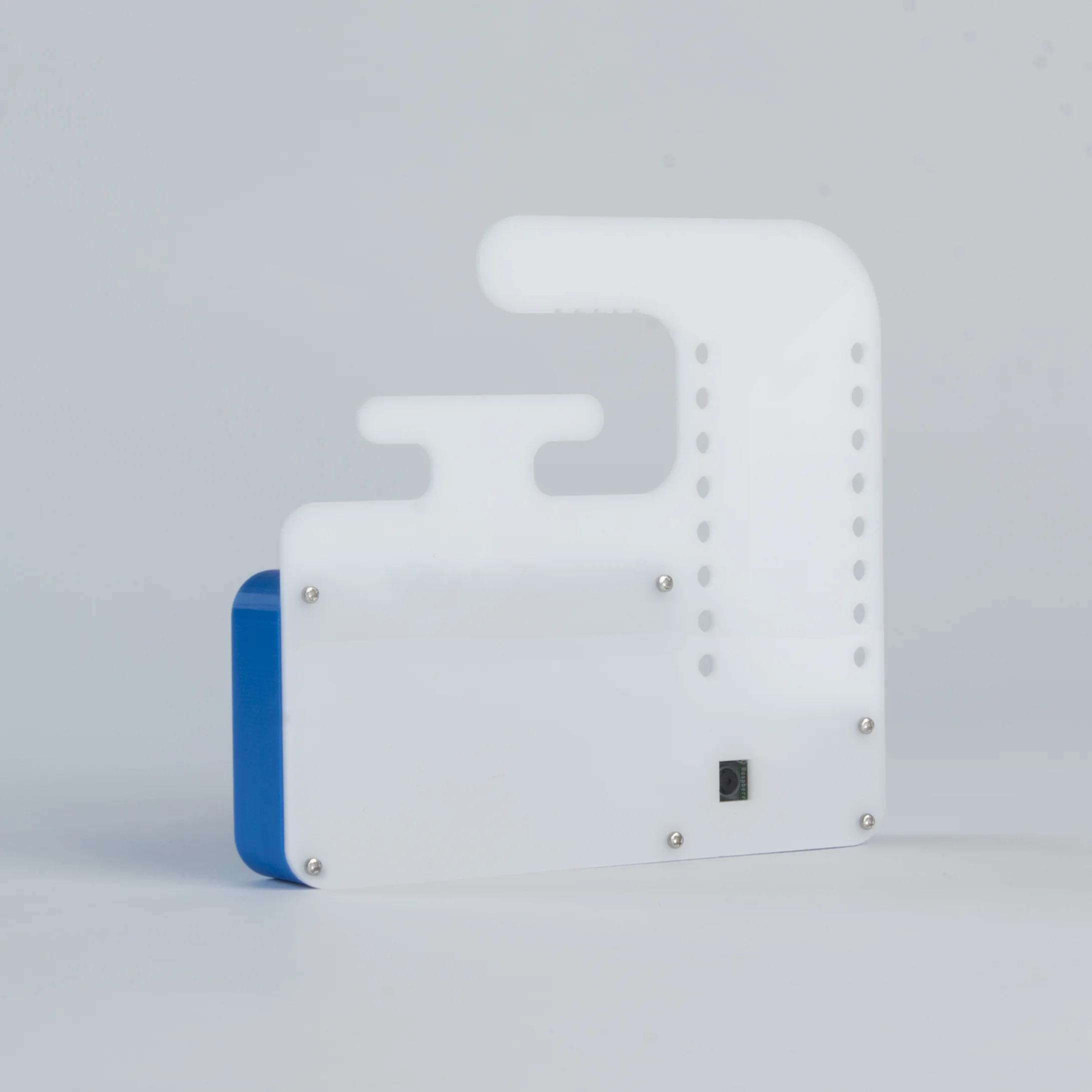 Camera with Lasercut Hanger - Type B This housing is made from a 3D printed shell and a lasercut acrylic rear panel. The panel features perforations for attaching a USB battery with cable ties or elastic bands, hooks for wrapping the USB power cable and a hook for hanging the camera itself.. more