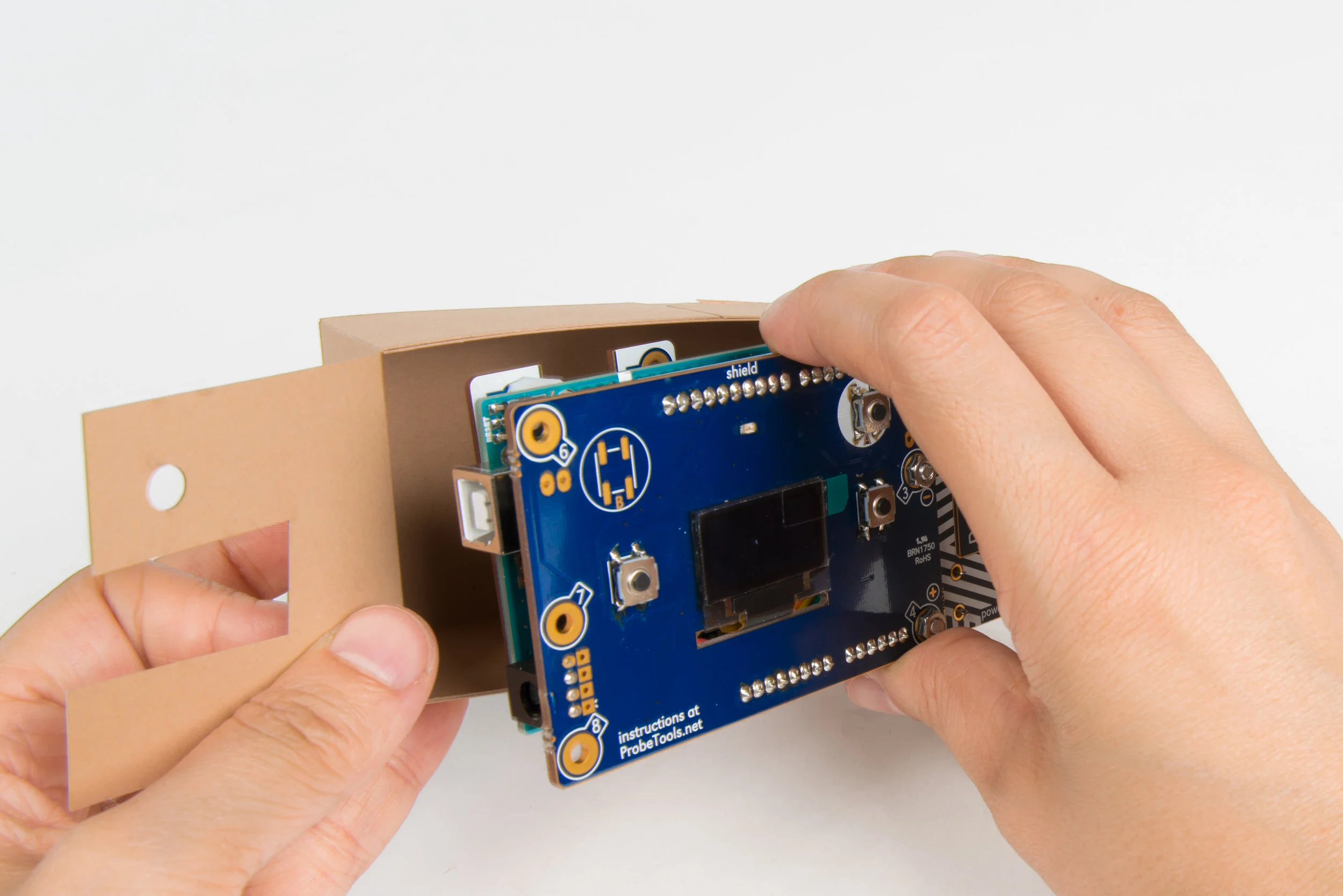 Step 26 Place the camera electronics in the inner case as shown, and close the flaps.