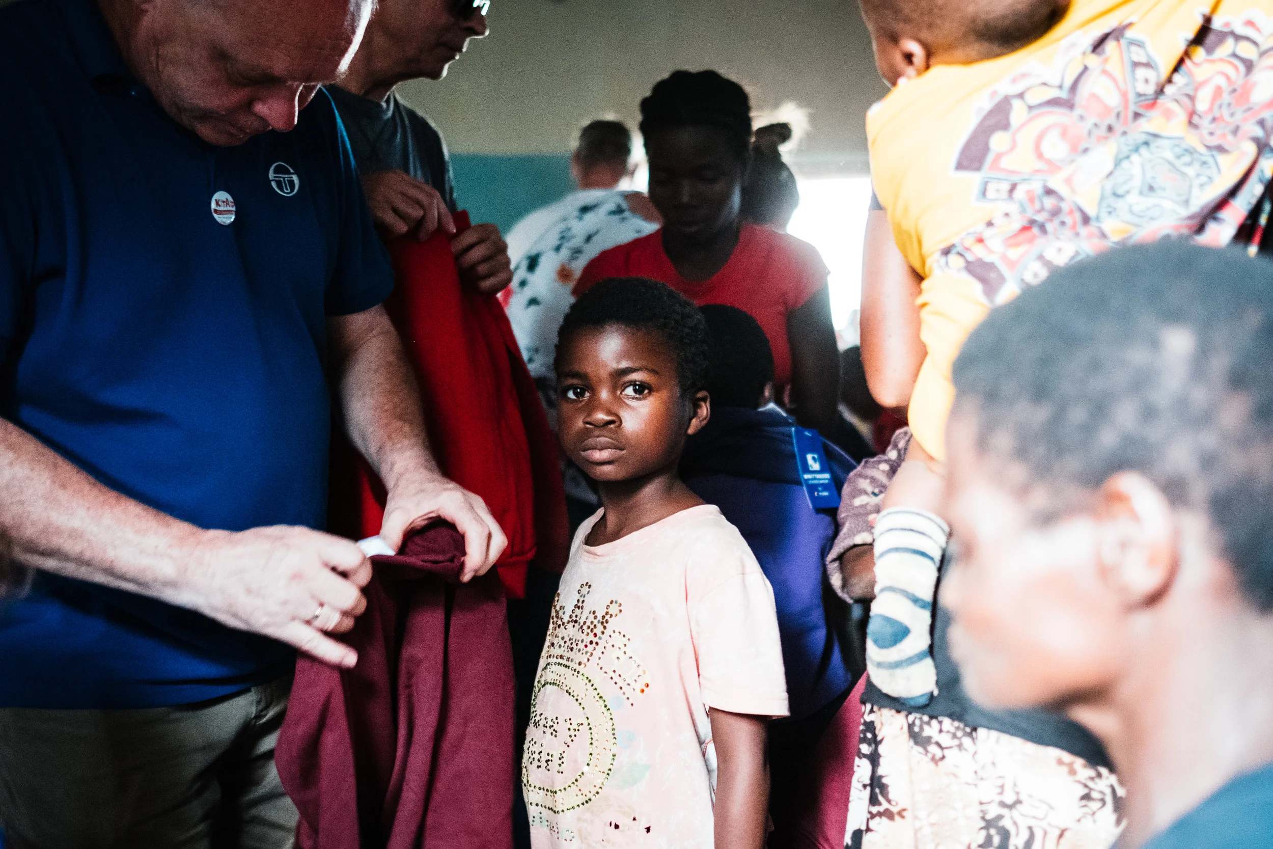 A child waiting to be given a new piece of clothing at the Chole centre