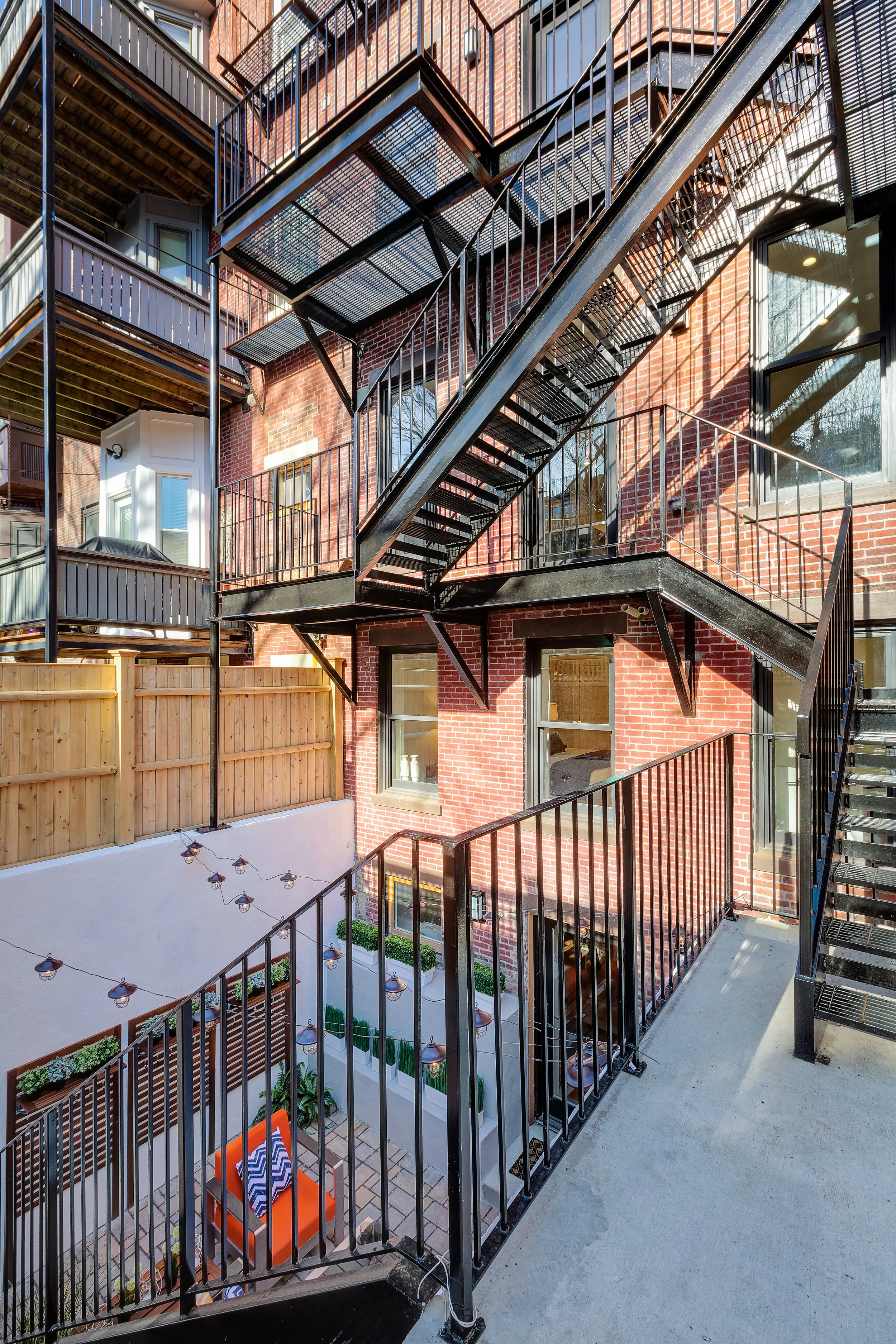 The New rear egress also provides direct access to parking and a balcony off of the kitchens