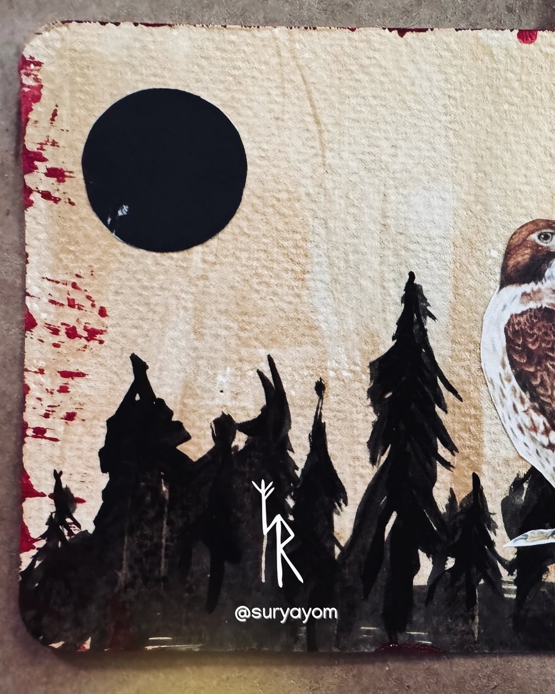 I return to posting today with a hand-painted postcard collage: a hawk beneath a black full moon.

The hawk appeared again in my lens recently &mdash; reminding me that life imitates art, and art imitates life. The hawk is a messenger, calling us to 
