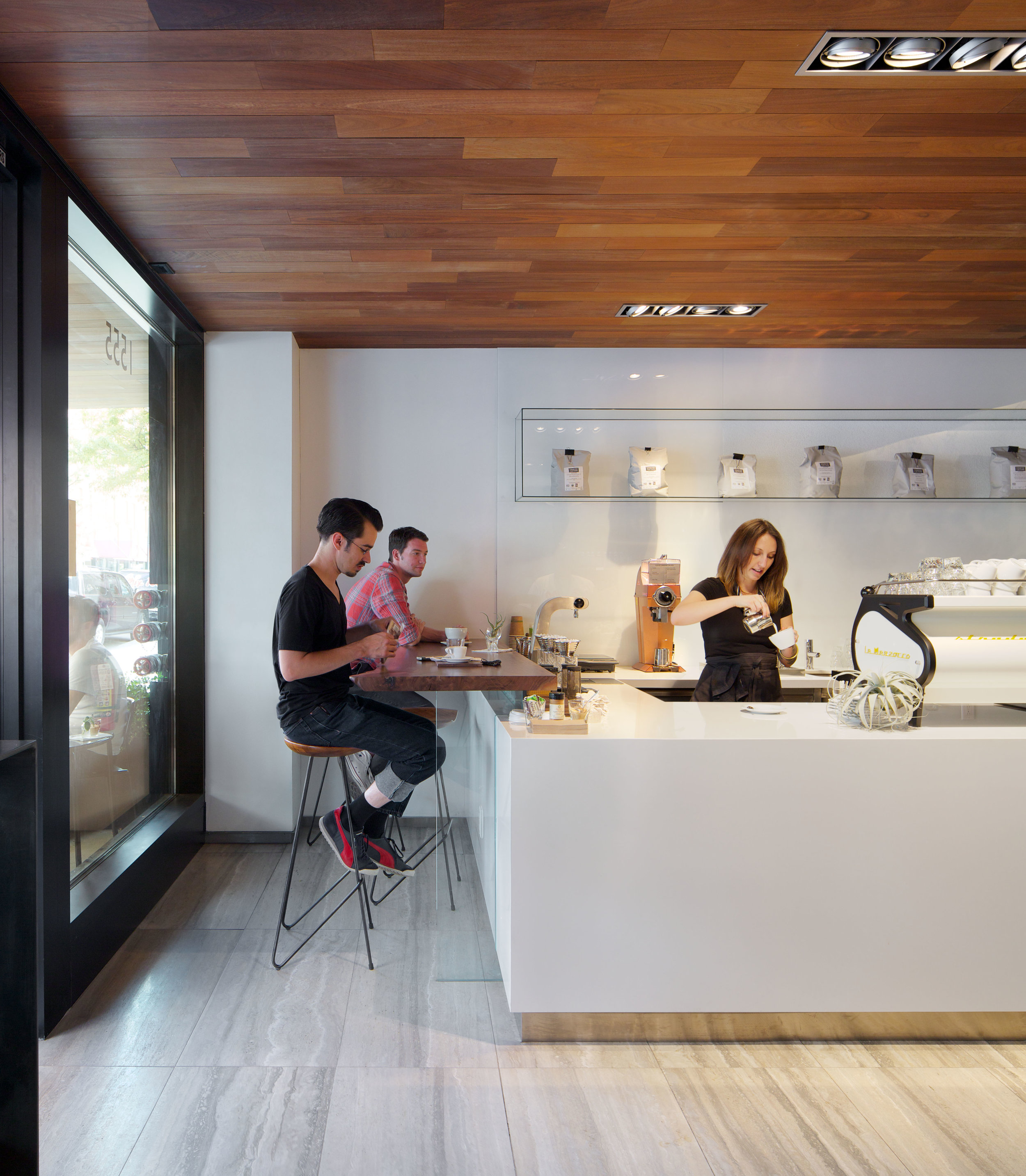 Every square inch is defined by necessity, and the design seamlessly houses all plumbing and electrical on the south white glass backsplash wall.