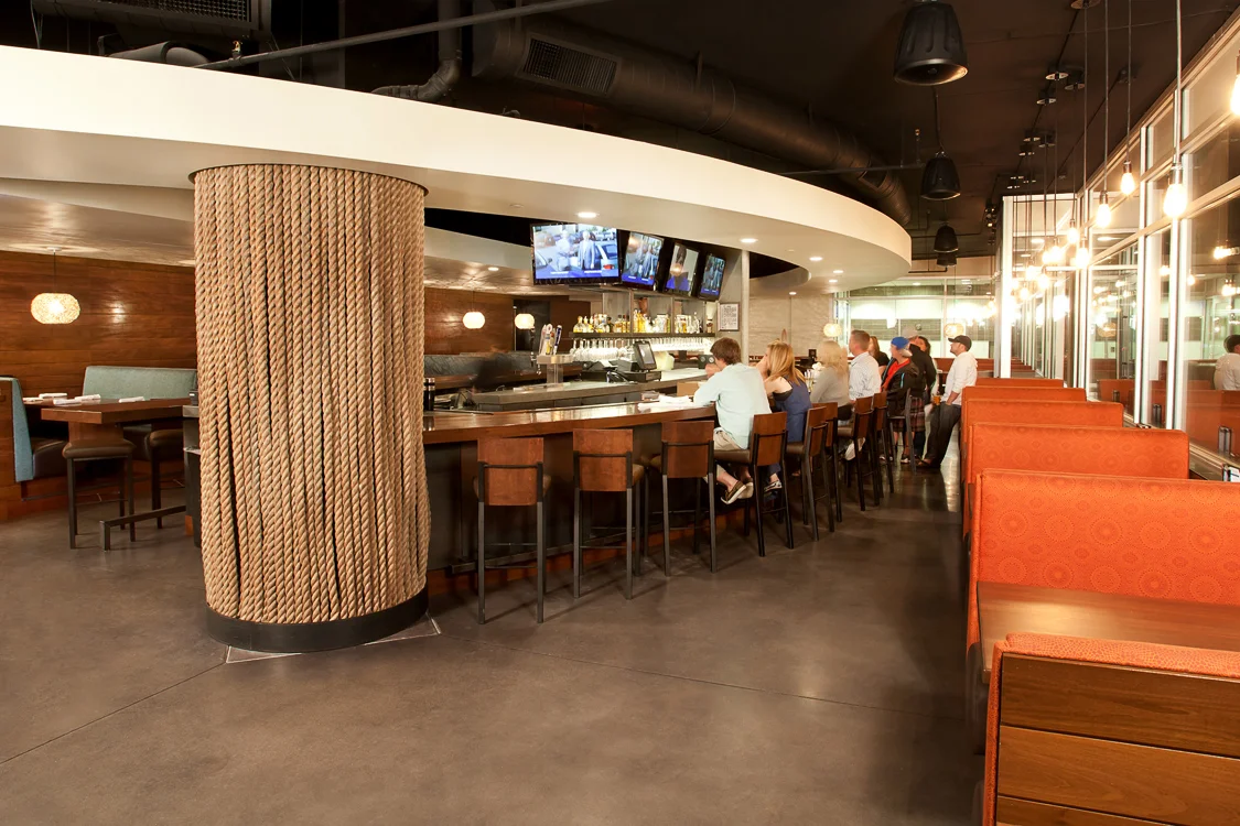 This curved bar acts as the primary focal point of the restaurant, creating a continued movement throughout the space.