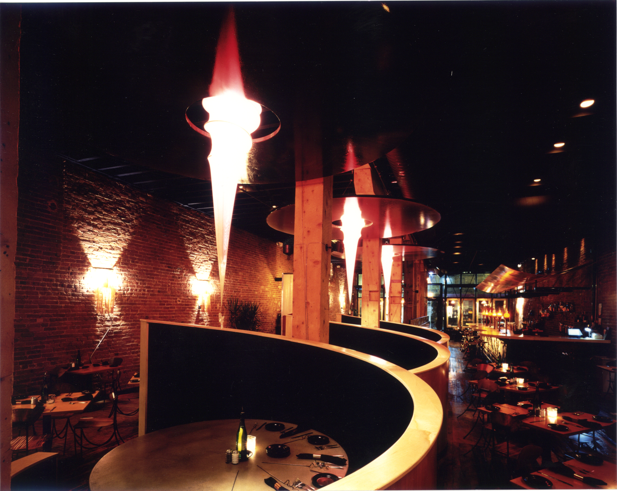 Images of flame, fire and warmth are explored in the custom lighting fixtures, interior color and material palette, custom steel fabrications, and placement of the grill/hearth.
