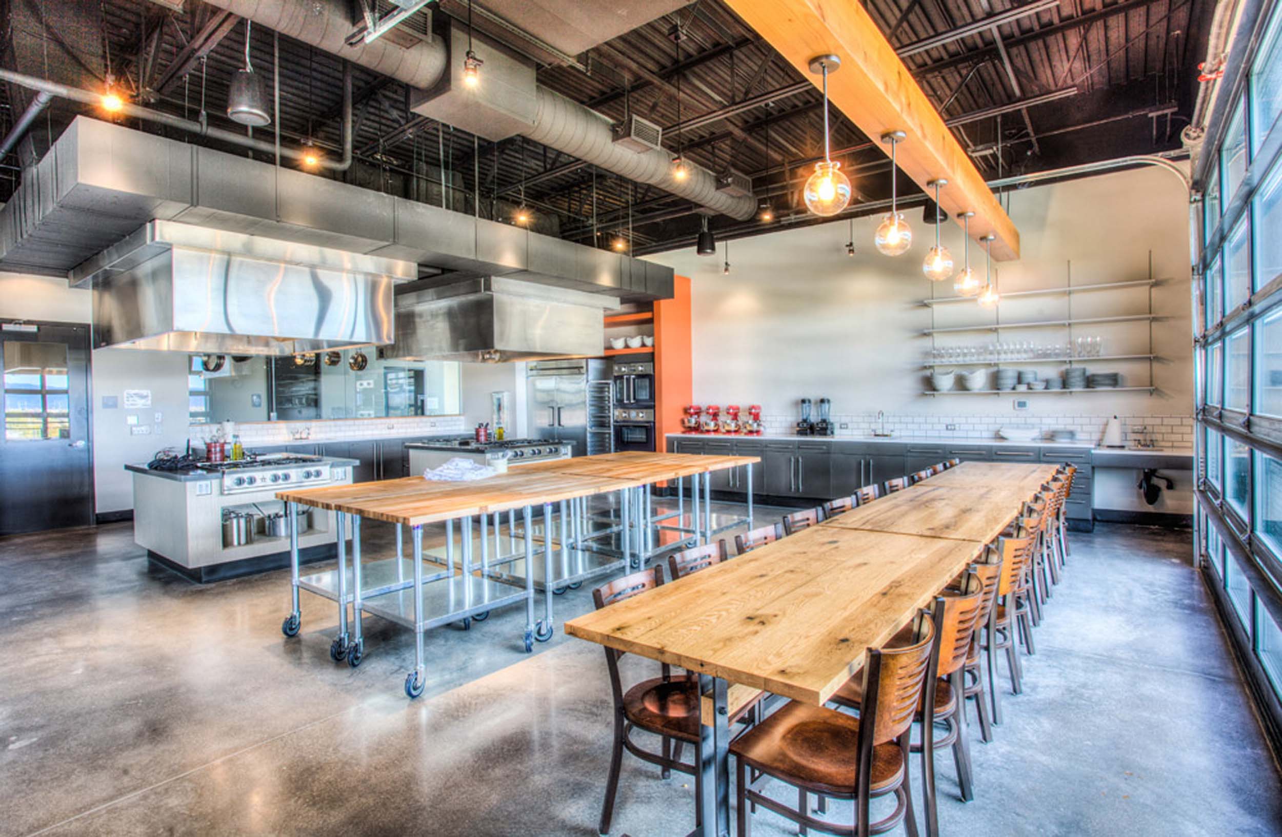 The second floor includes three kitchen classrooms, a wine bar, a prep kitchen, and additional support space.