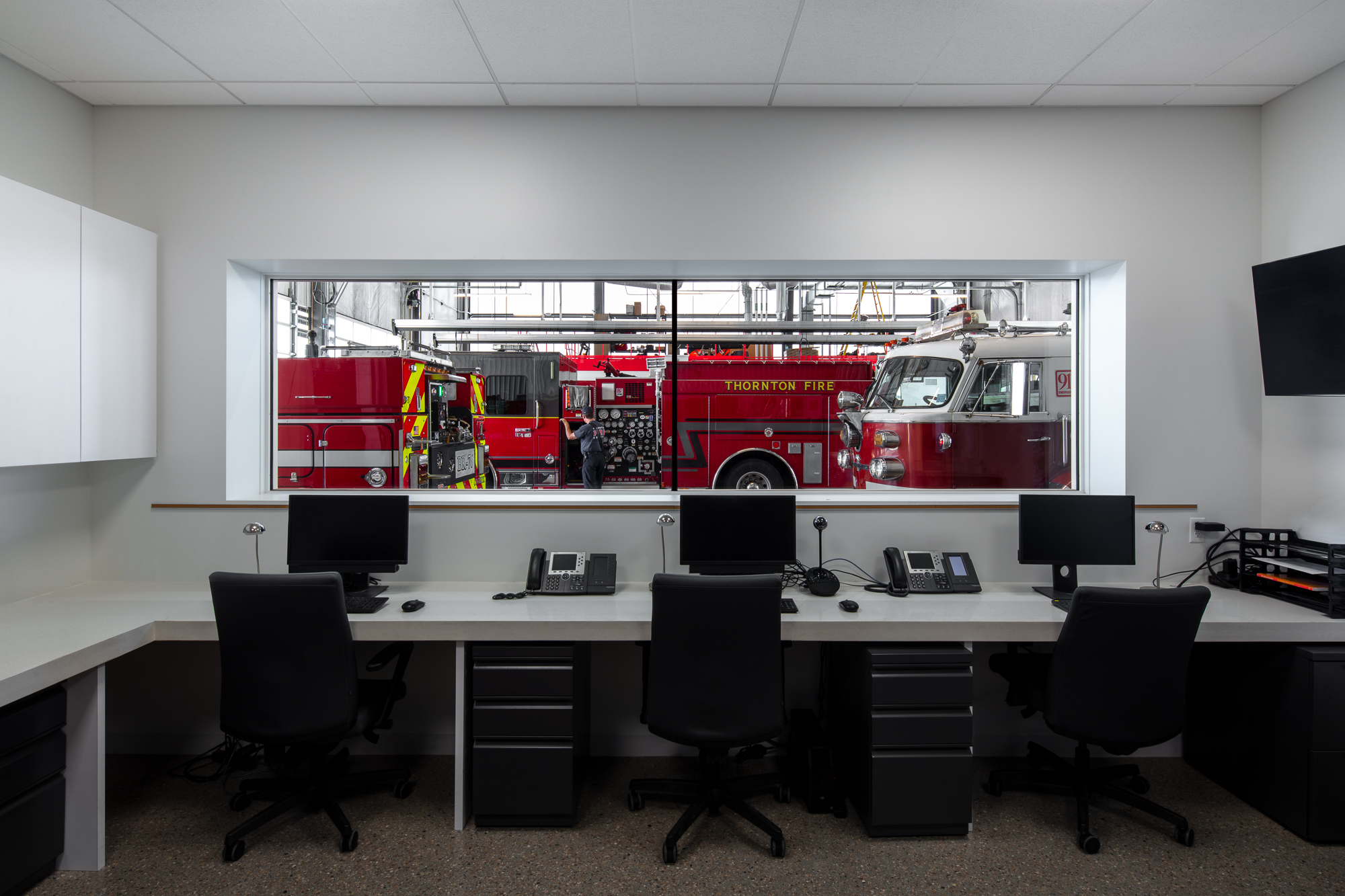 The fire department crew office provides a wide-framed view connecting the crew with the apparatus bay.