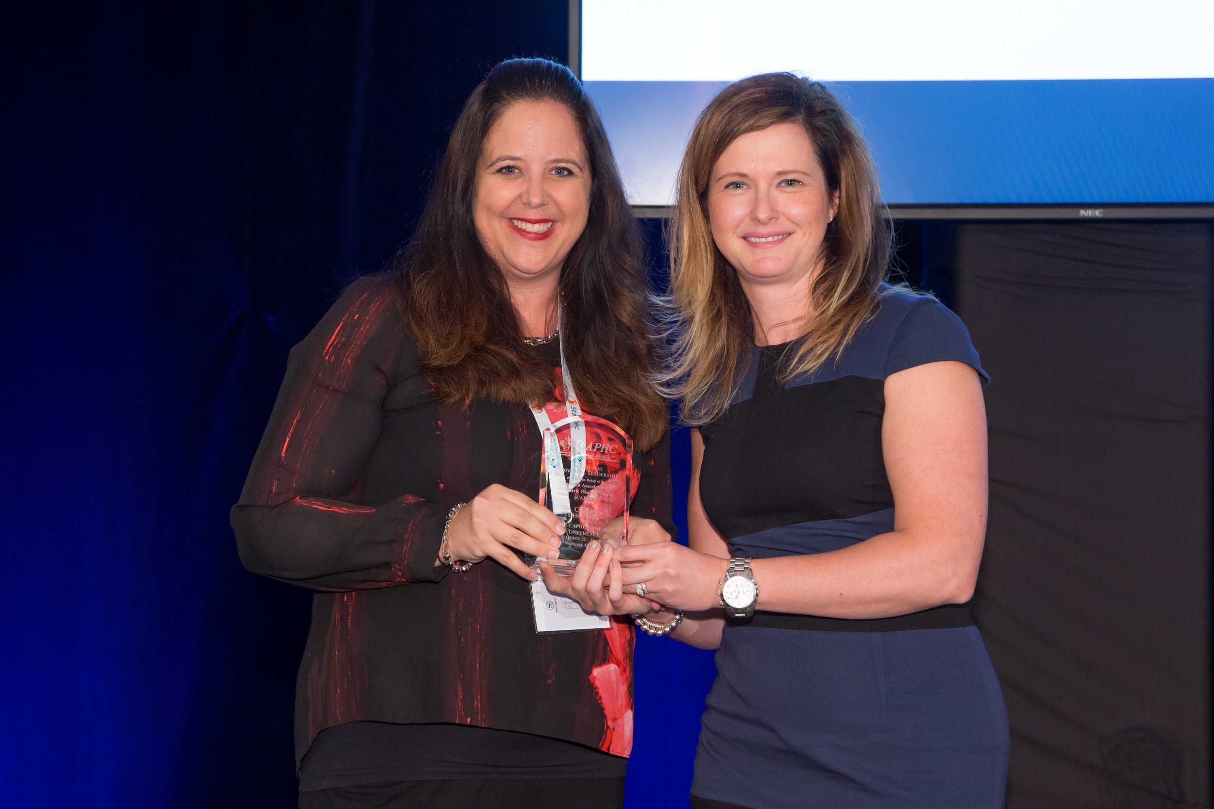 Dr. Christine Chambers being presented the CAPHC Award for Individual Leadership by CAPHC President & CEO, Emily Gruenwoldt - Photo: Dufour/Egan