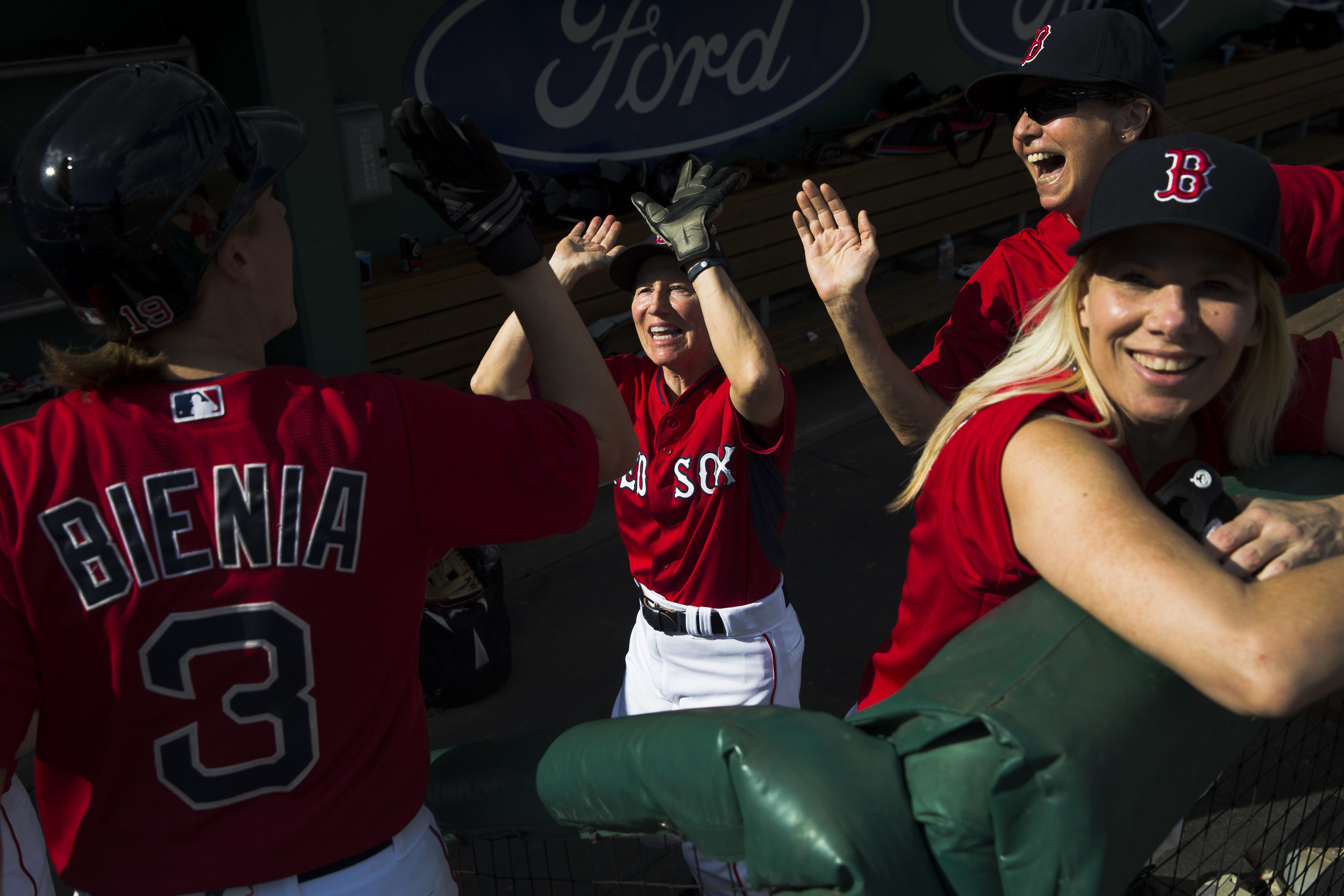  Members of the Comets baseball team are all smiles as they congratulate teammate Lisa Bienia (3) after she crossed home plate to score a run against the Belles during the second annual Women's Fantasy Baseball Camp at JetBlue Park Thursday, Jan. 12,