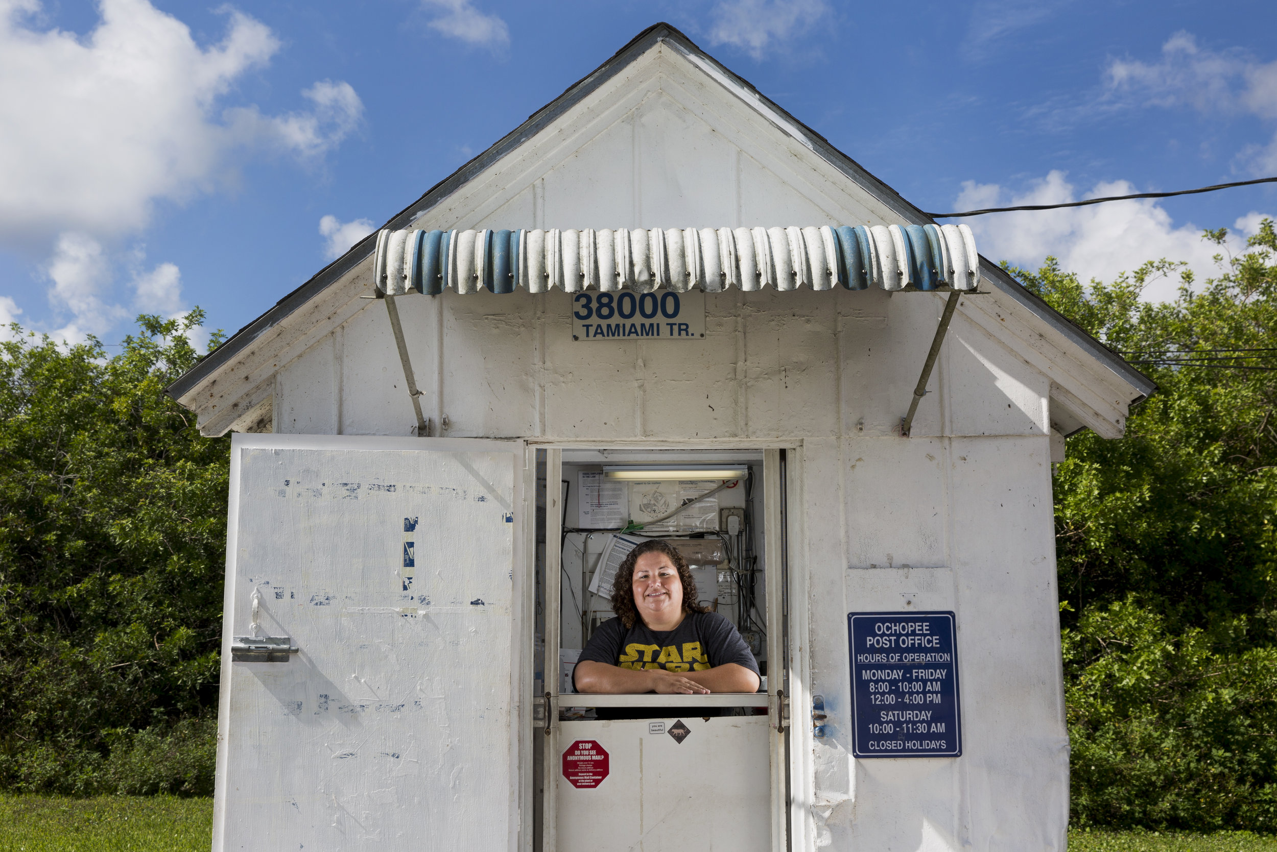 Post office clerk Shannon Mitchell inside the Ochopee Post Office, known as the smallest in the United States, Thursday, June 2, 2016 in Ochopee, Fla. In October of 1998 Shannon, a native of Everglades City, Fla., passed her postal exam and started working as a mail carrier at Marco Island, just a short drive from her home town. Fast forward nearly 20 years and she is still hard at work. "I love it here," she said. "We're lucky to still be here." The tool shed turned post office serves the area's 900 residents spanning three different counties, including the Miccosukee Indian Tribe. 