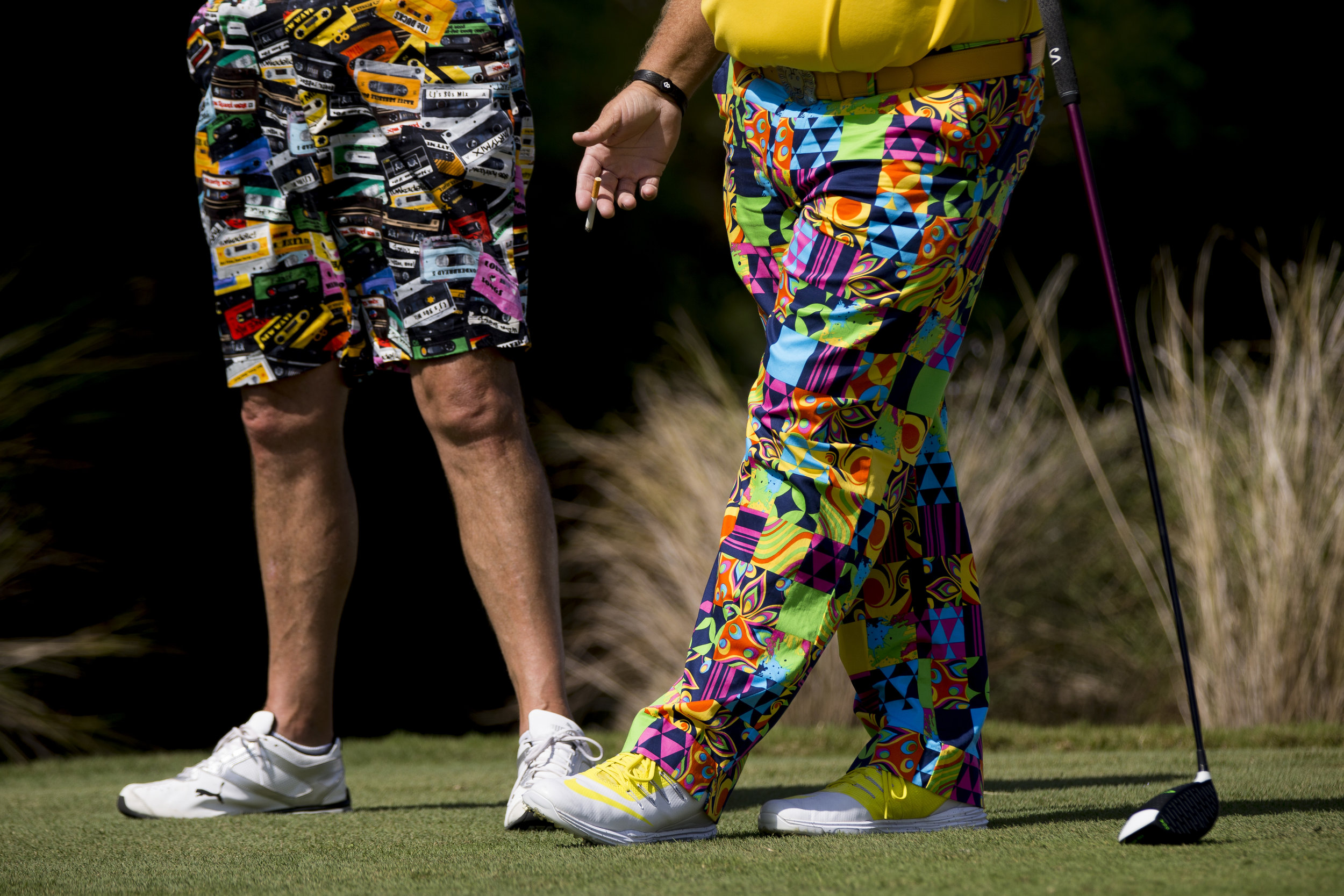  PGA Tour Pro John Daly, right, smokes a cigarette as he speaks with his caddy prior to teeing off during the Chubb Classic Pro-Am at TwinEagles Club Wednesday, Feb. 15, 2017 in Naples, Fla.&nbsp; 