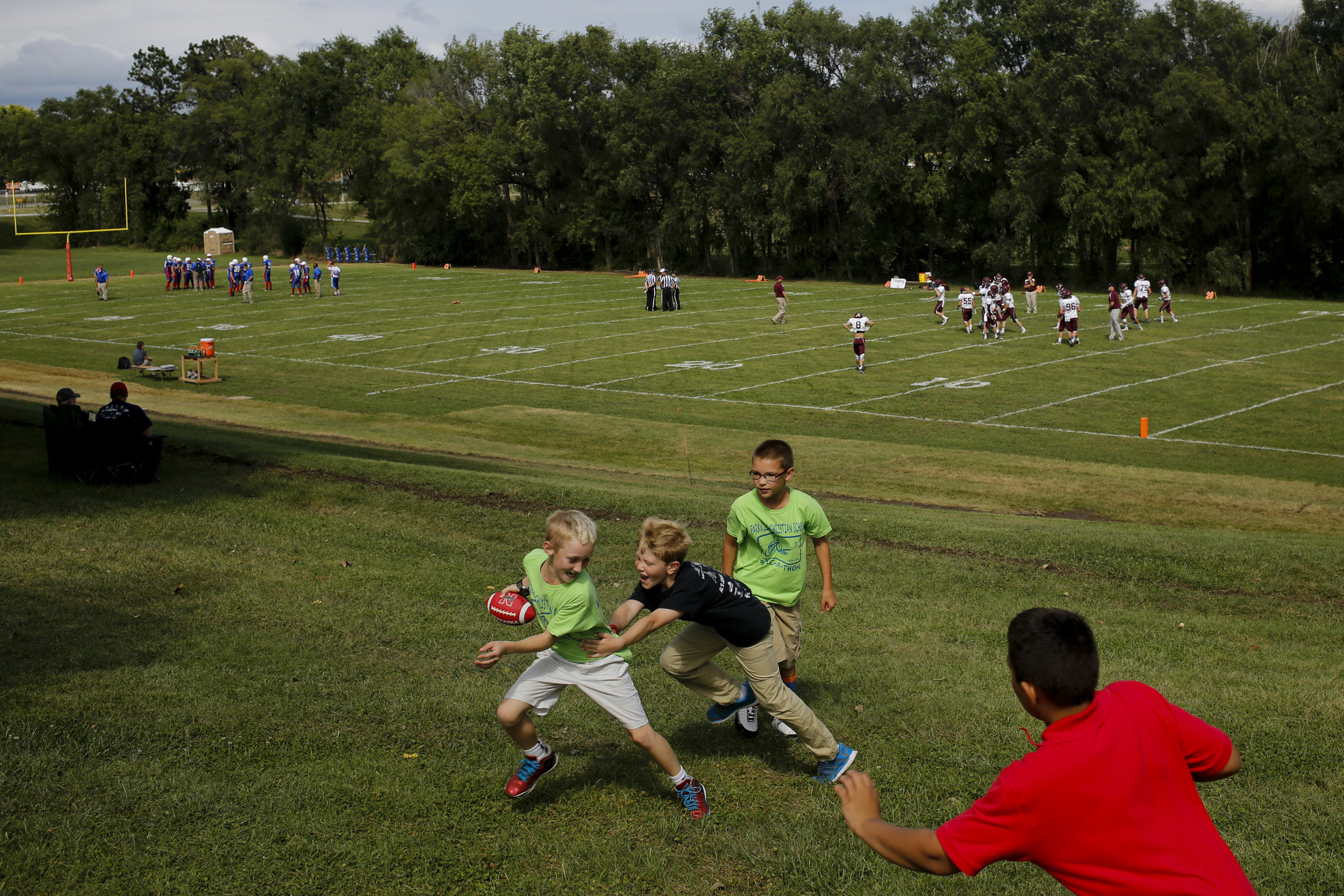  Children play their own pick-up game of football minutes before Parkview Christian football hosted Lyons-Decatur Northeast Friday August 28, 2015 at Parkview Christian High School in Lincoln, Nebraska. 