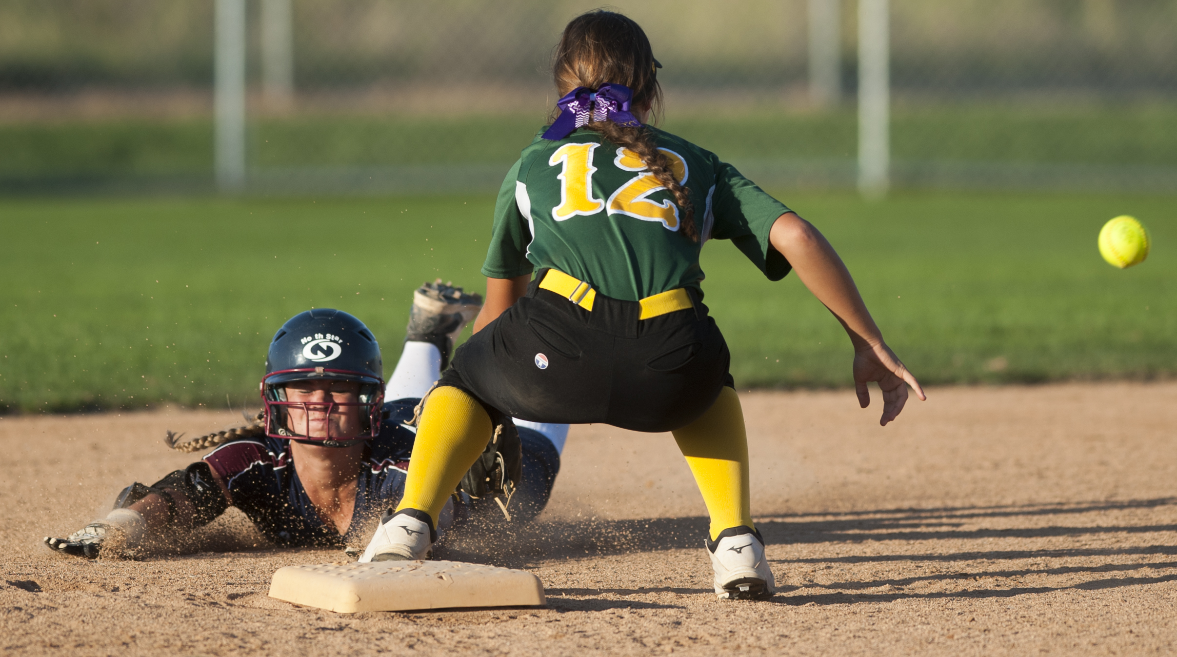  &nbsp;Following two errors during the play North Star's Elaina Mayer successfully slides into second base on a bunt before Pius X's MacKenzie Helman (12) can make the tag in the fifth inning of action Monday Sept. 21, 2015 at Doris Bair Softball Com