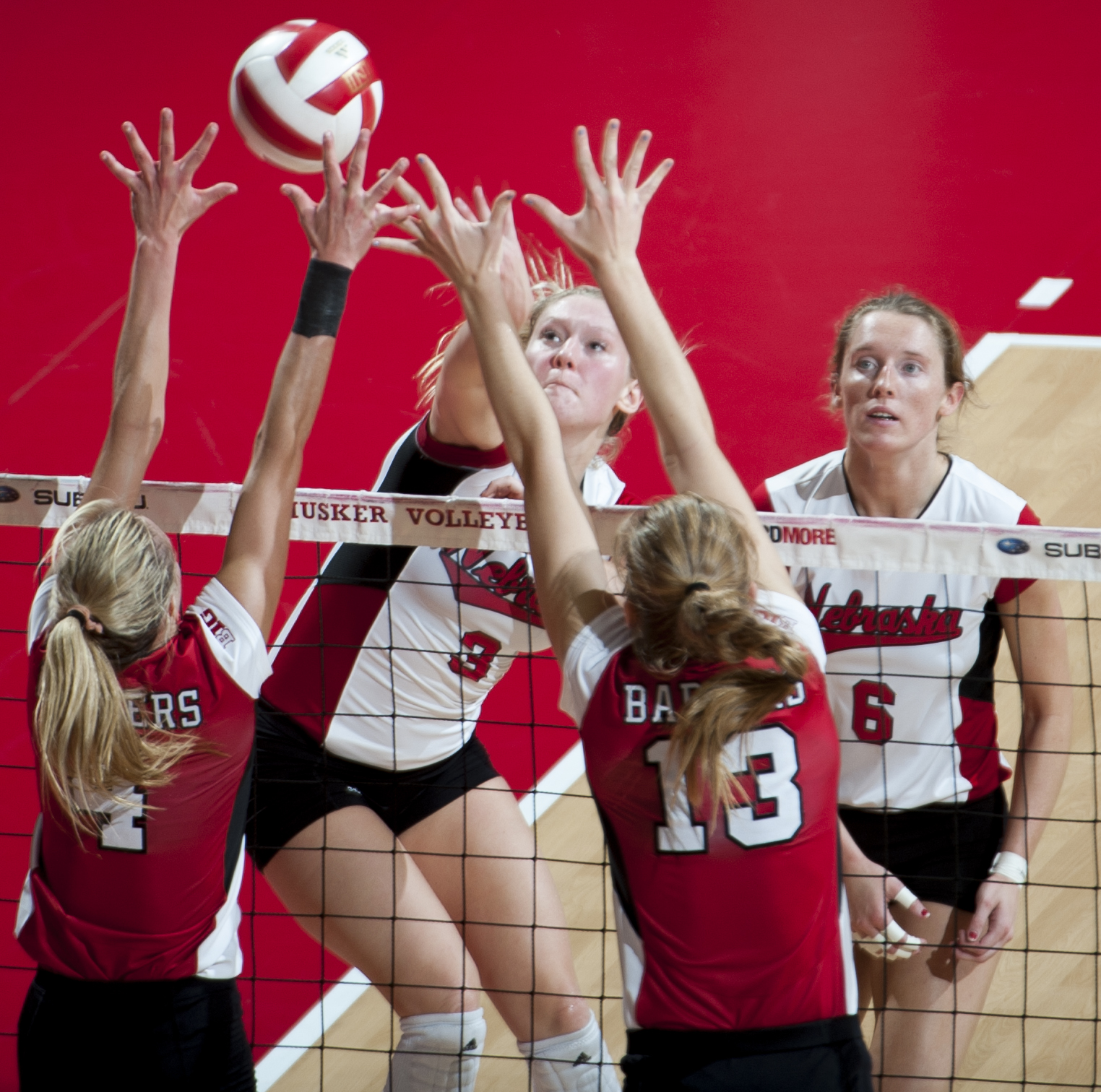  Nebraska's Kelly Hunter (3) spikes the ball against Wisconsin's Kelli Bates (4) and Haleigh Nelson (13) in the fourth set of action at Devaney Sports Center in Lincoln Saturday Oct. 24, 2015. The Huskers would win the first set of the match but then