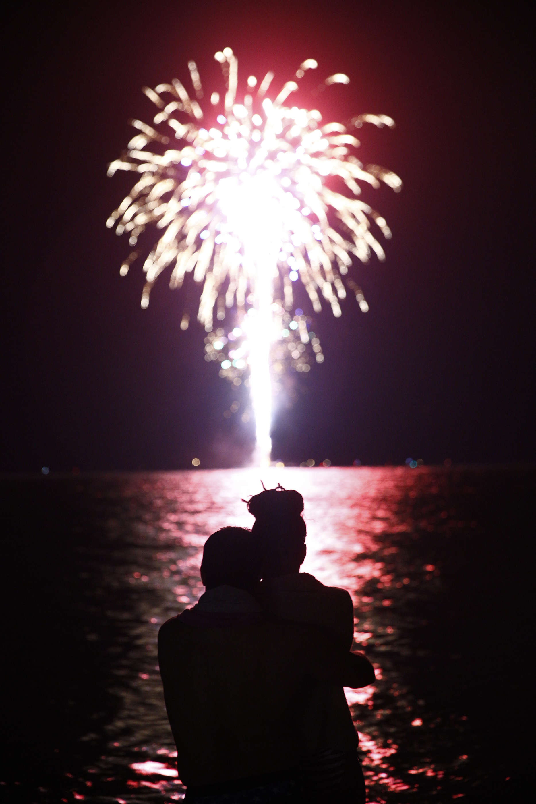 Luis Lorenzo and his wife Aloima, both of Naples, embrace as they watch the fireworks off of Naples Beach Monday, July 4, 2016. This will be a day the couple will soon not forget. Originally from Cuba, Luis gained his United States citizenship February 26, 2016. "For me this a great experience," Luis said. "We're here baby!"